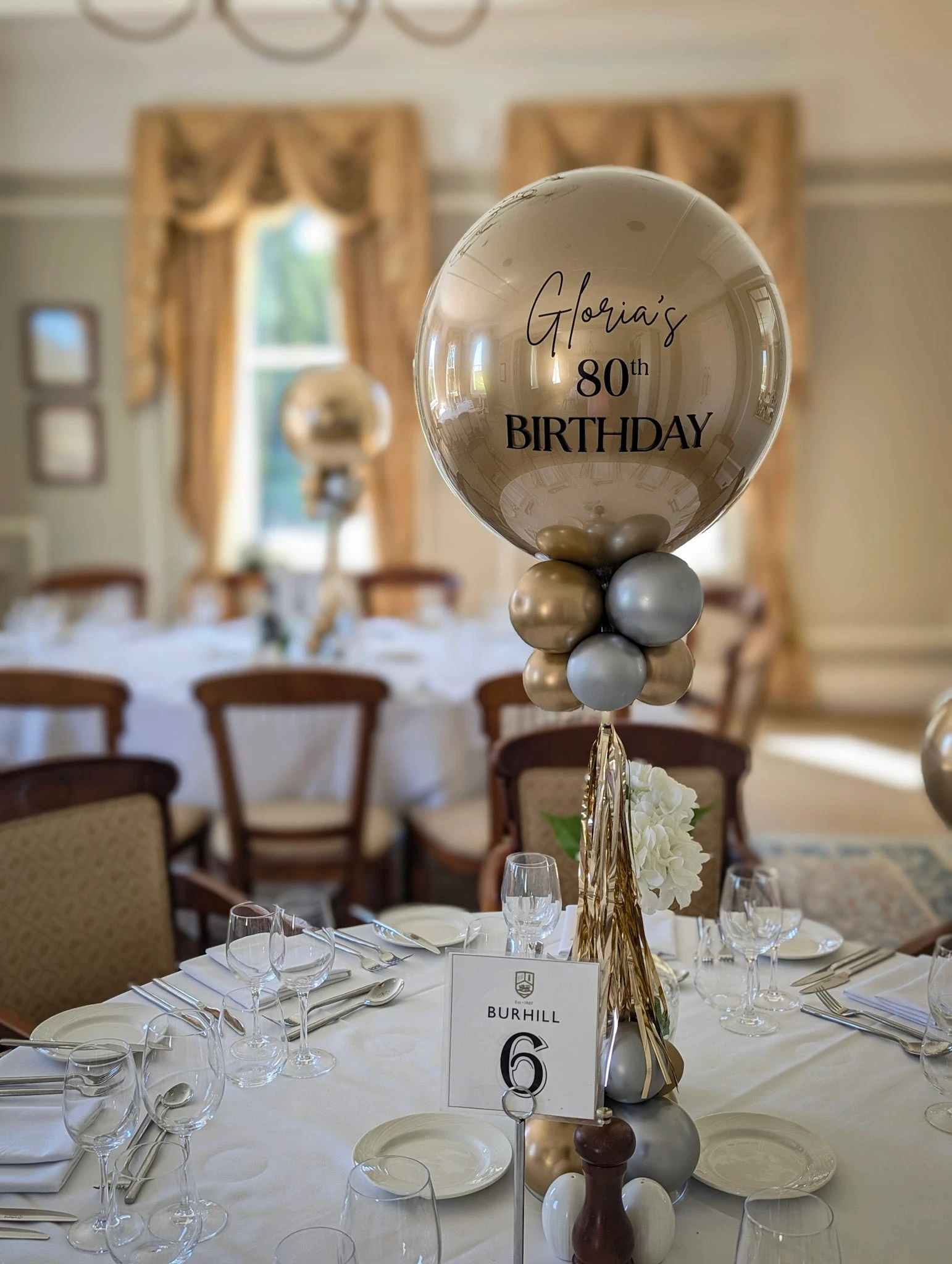 Balloon and floral table centrepieces styled for an event