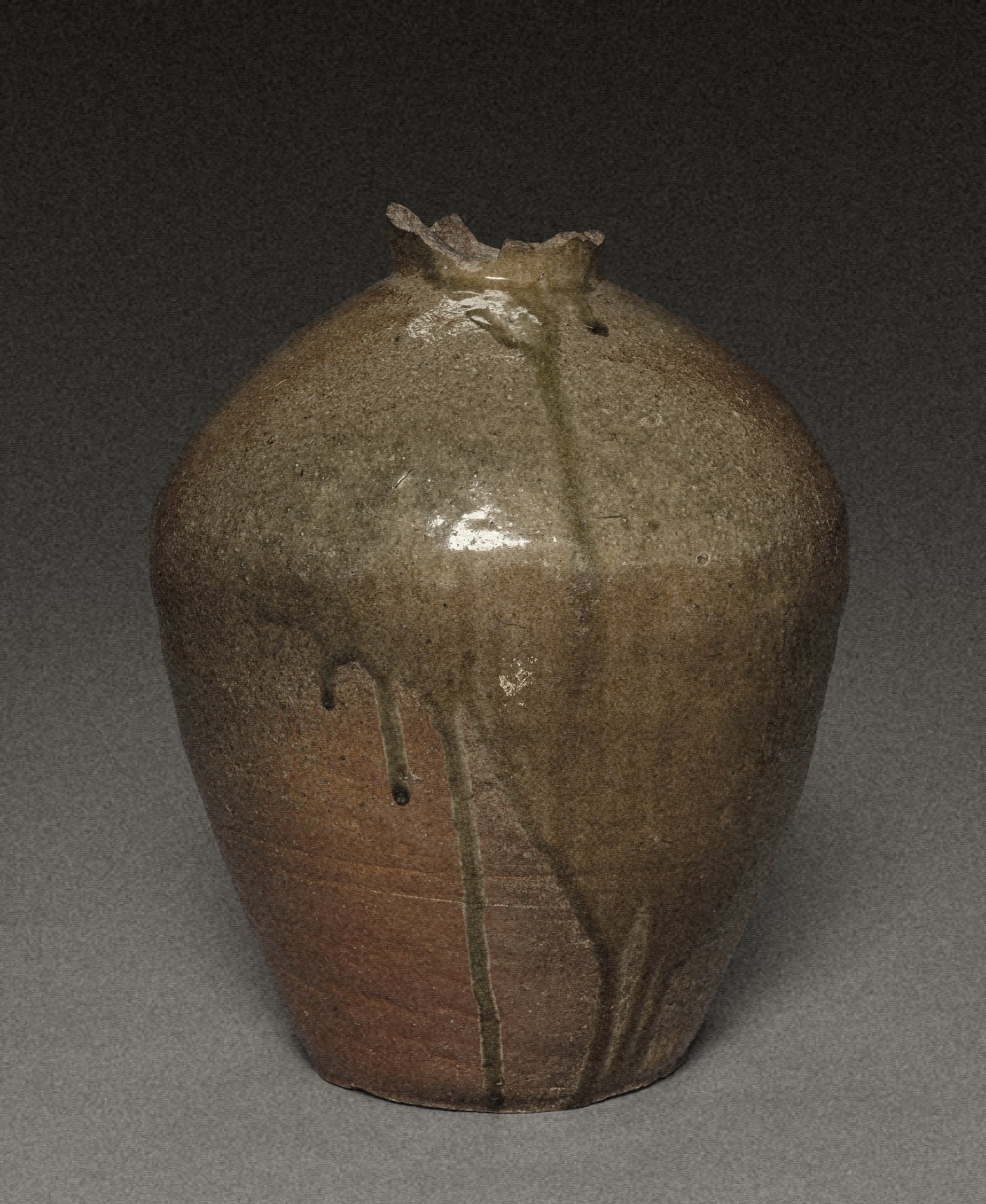 stoneware jar with glaze drips running down the shoulder