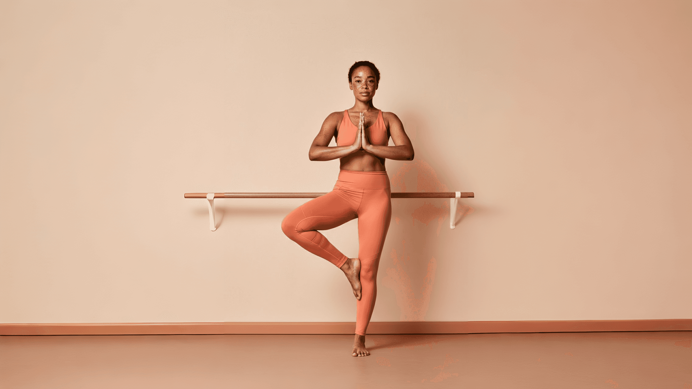 Woman standing in a yoga pose.