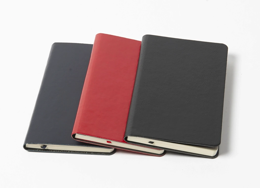 Set of hardbound journals in black, red, and navy covers
