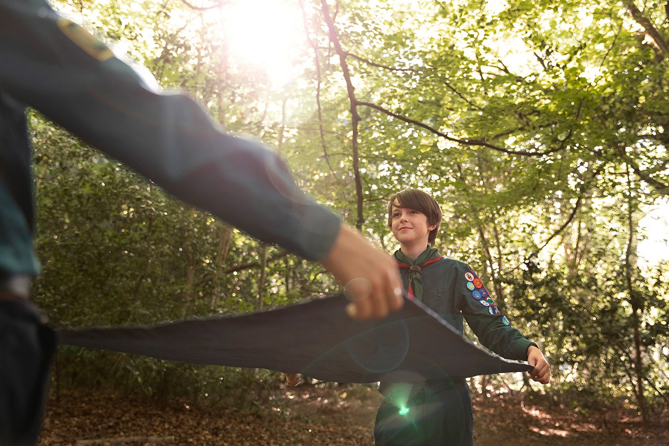 Snowboarder enjoys a downhill run on a sunny day.