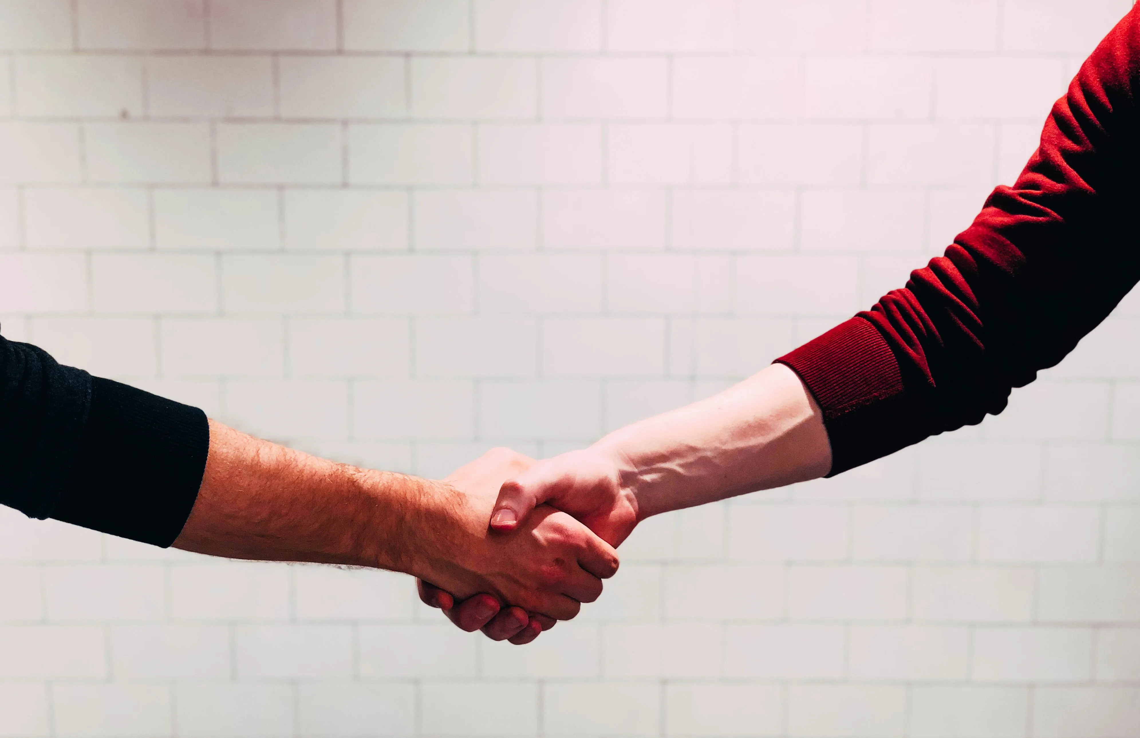 Handshake between a company representative and PEO