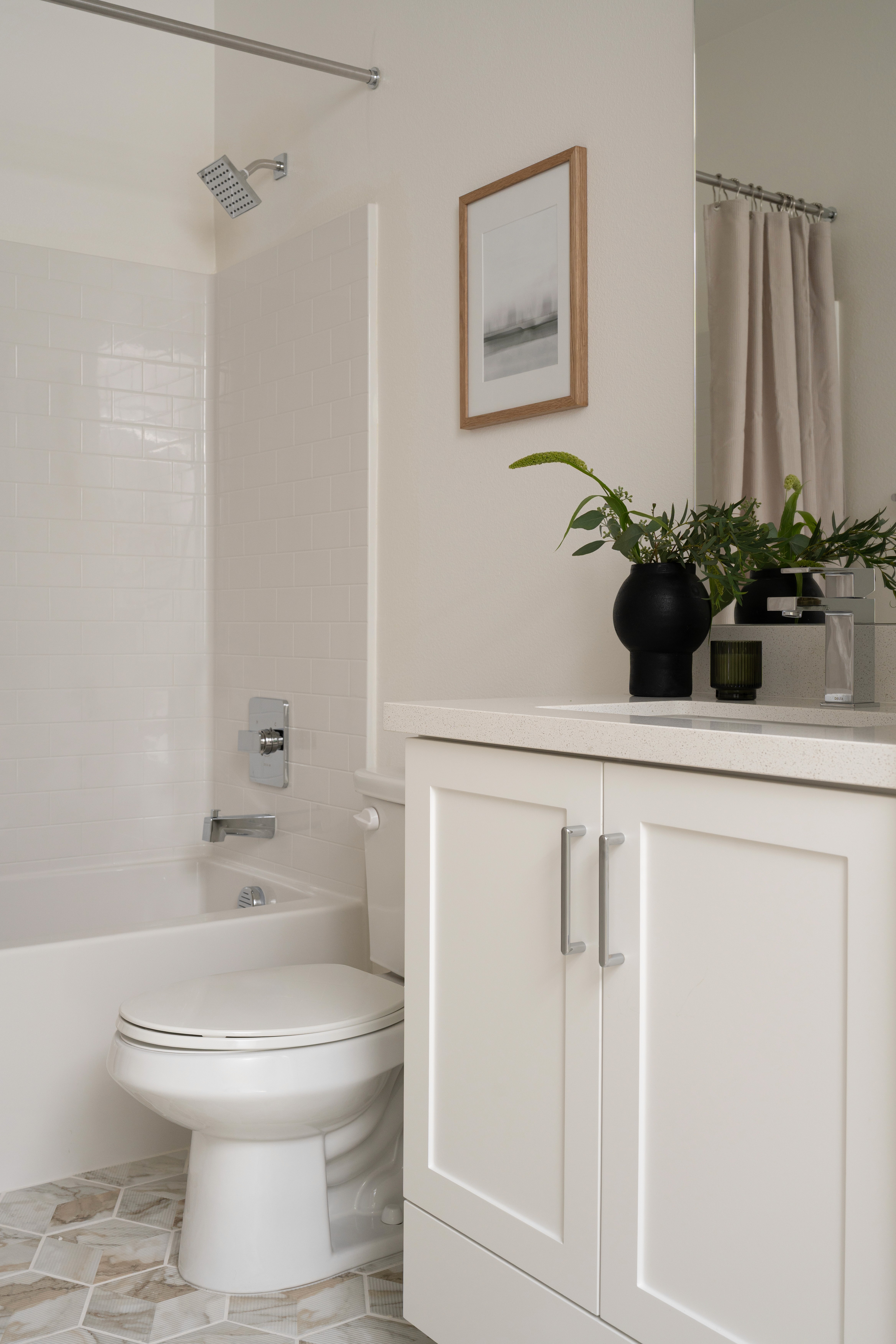 Guest bathroom with artwork and greenery