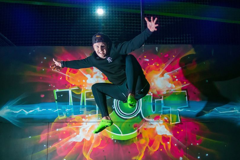 Young adult jumoing in the air at Flip Out Trampoline Park