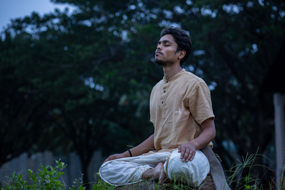 Elf woman in white dress raising hands by the river