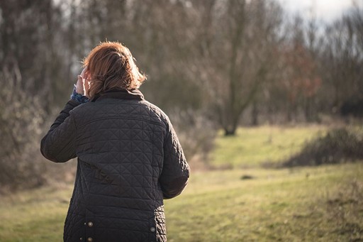 Ambigous photo of a woman with ginger hair in park in the winter
