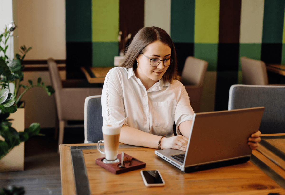 girl using laptop at restaurant