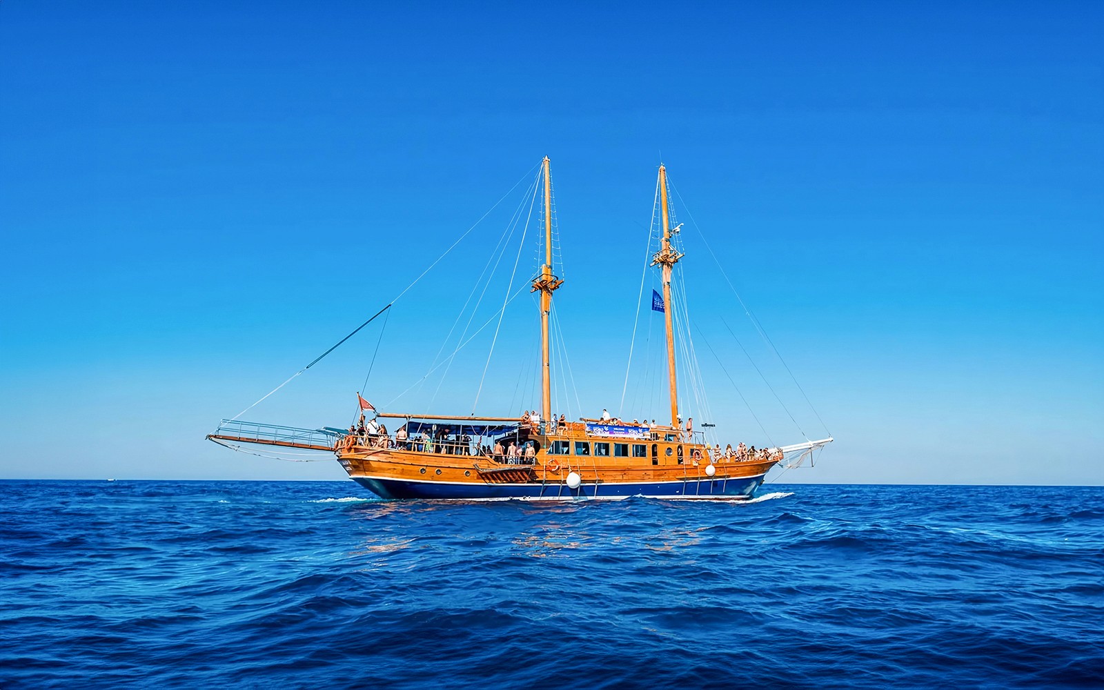 Turkish gulet sailing from Sliema to Gozo and Comino with passengers on deck.