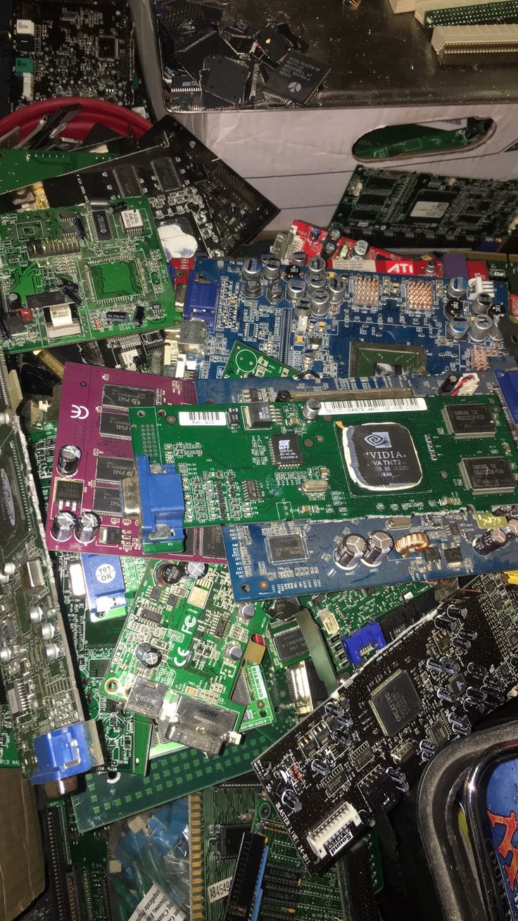 A pile of used graphics cards and circuit boards, examples of used computer parts sourced for upgrades