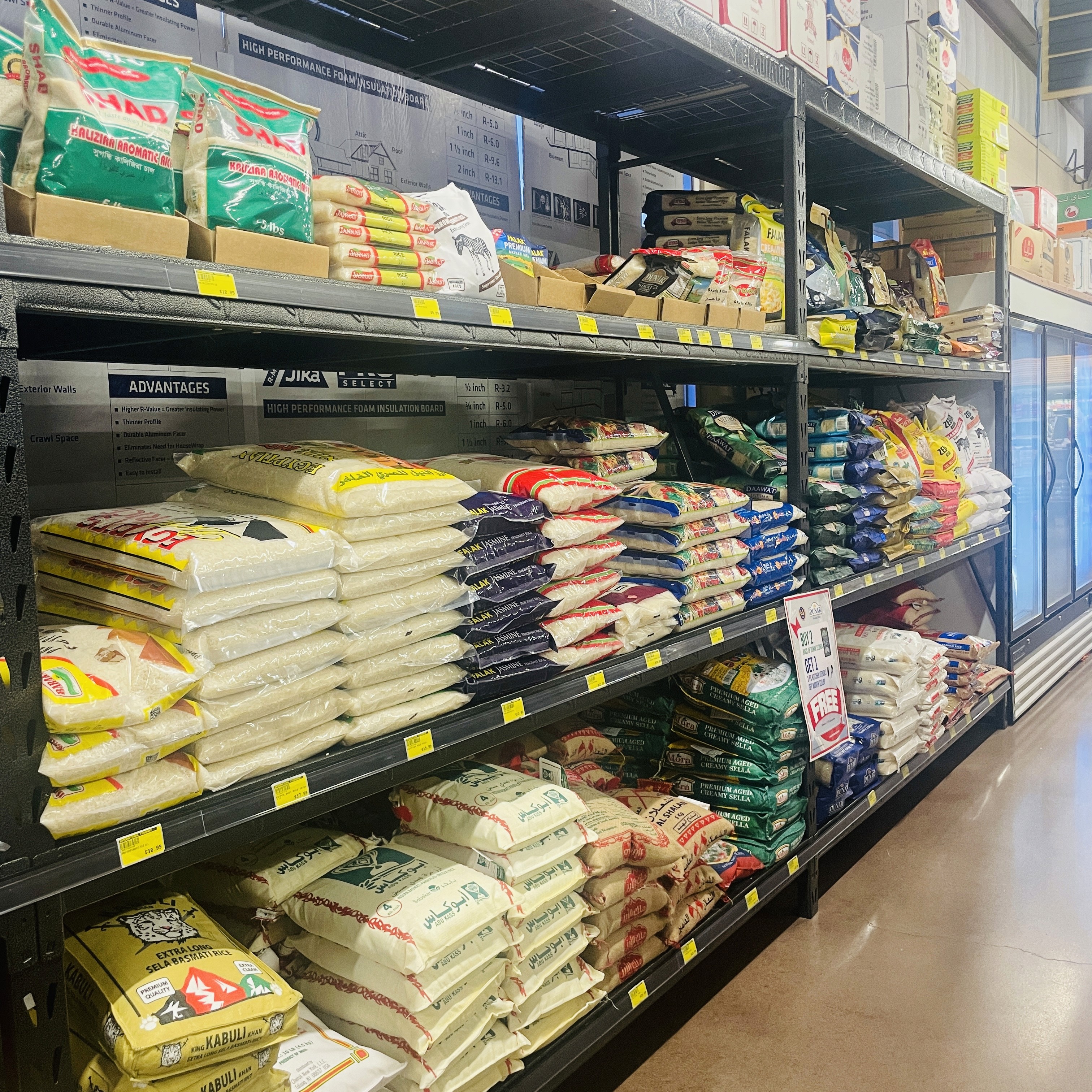 Shelves stocked with various rice brands including basmati and jasmine rice at International Food Market Orlando.