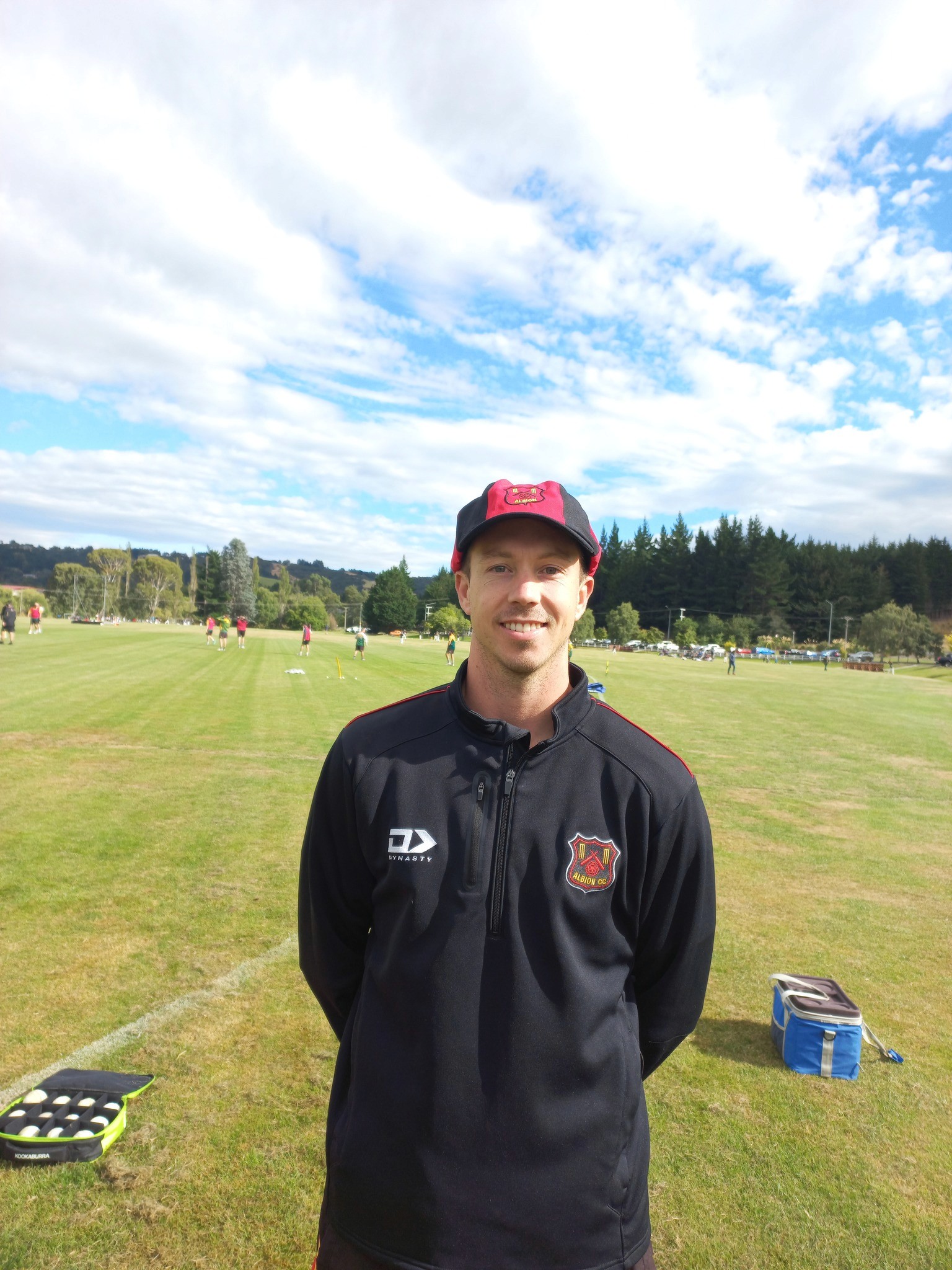 man in white shirt and brown pants wearing brown cowboy hat standing on green grass field