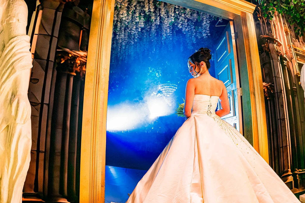Bride at the blue-lit enchanted doorway of Pandora Hall, Stalla Suites QC