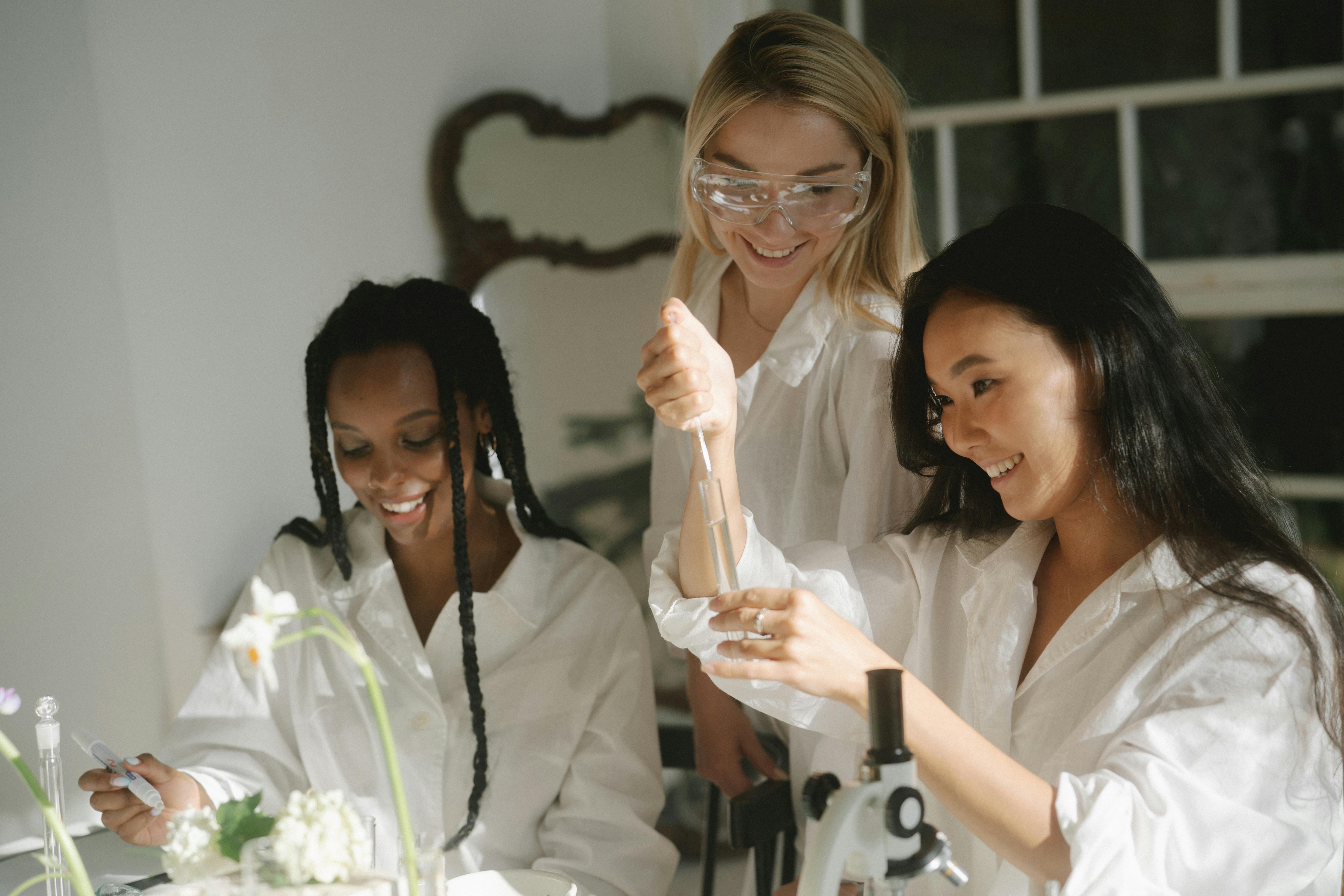 Women Wearing Laboratory Gown While Experimenting in a scshool science lab