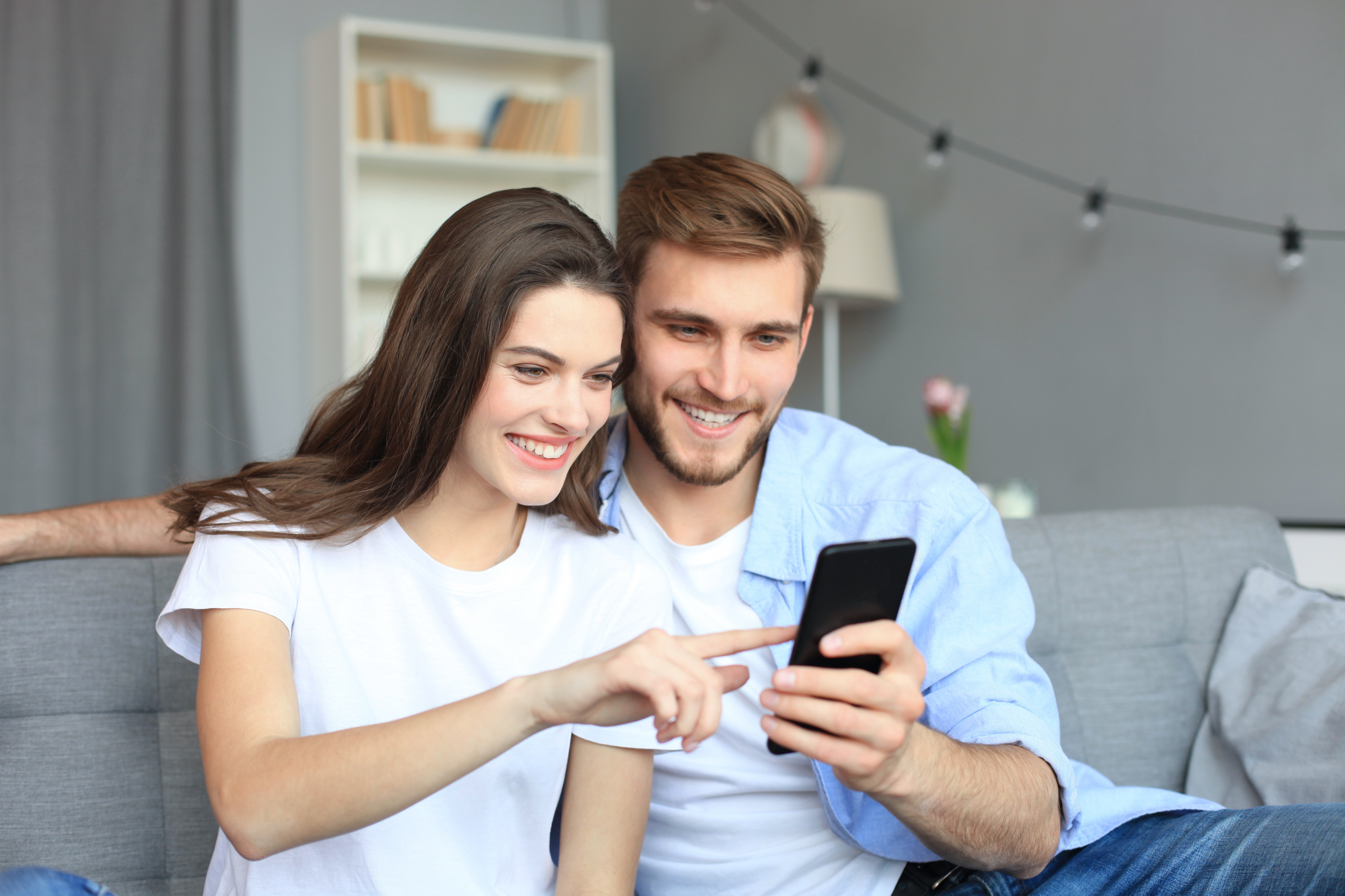 novihome homebuyers looking at phone