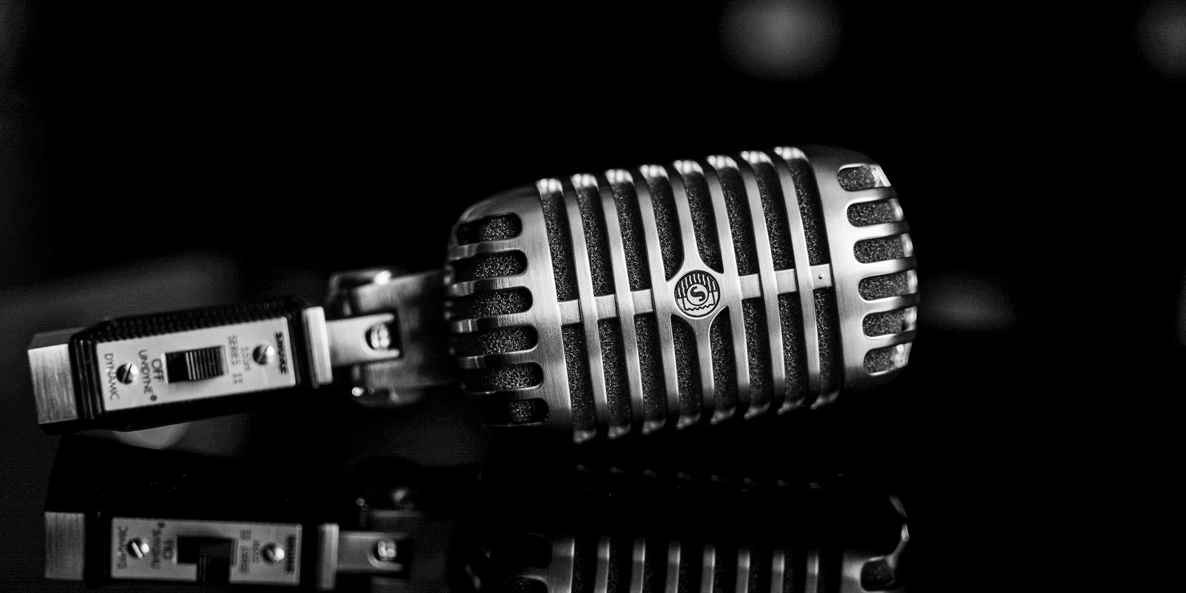 picture of a vintage sennheiser metal microphone tilted on its side