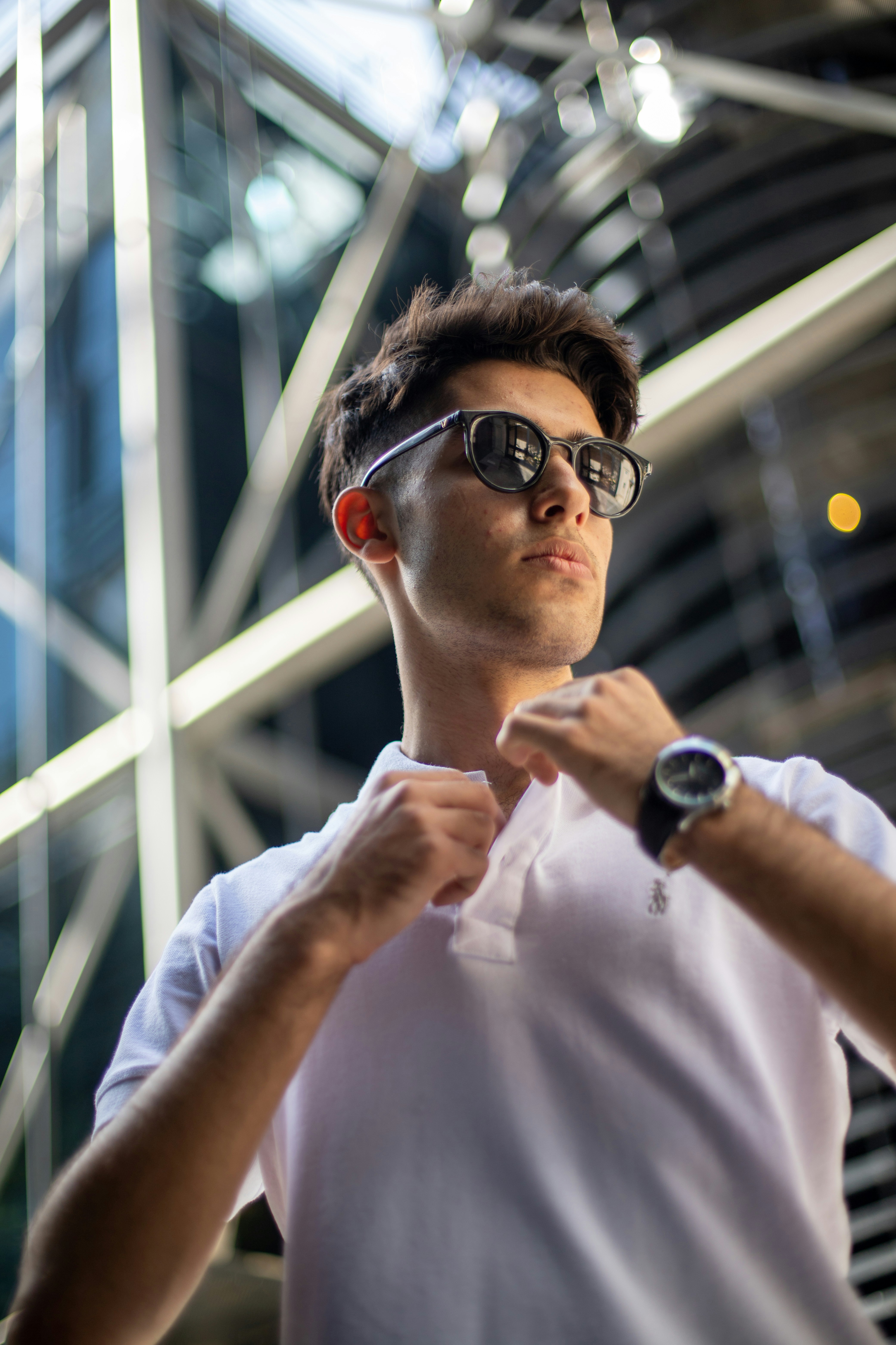 a man in a white shirt and sunglasses