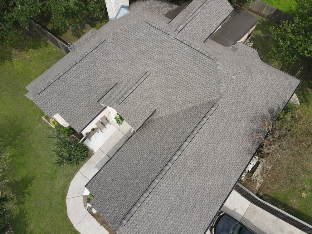 One-story house with a cross hipped roof, gaf shingles, and a ridge vent.