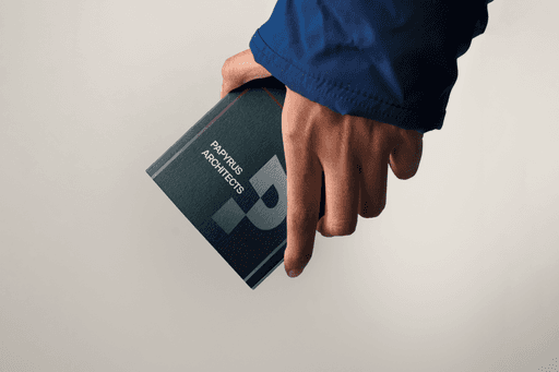 Leaflet print in hand, studio lighting