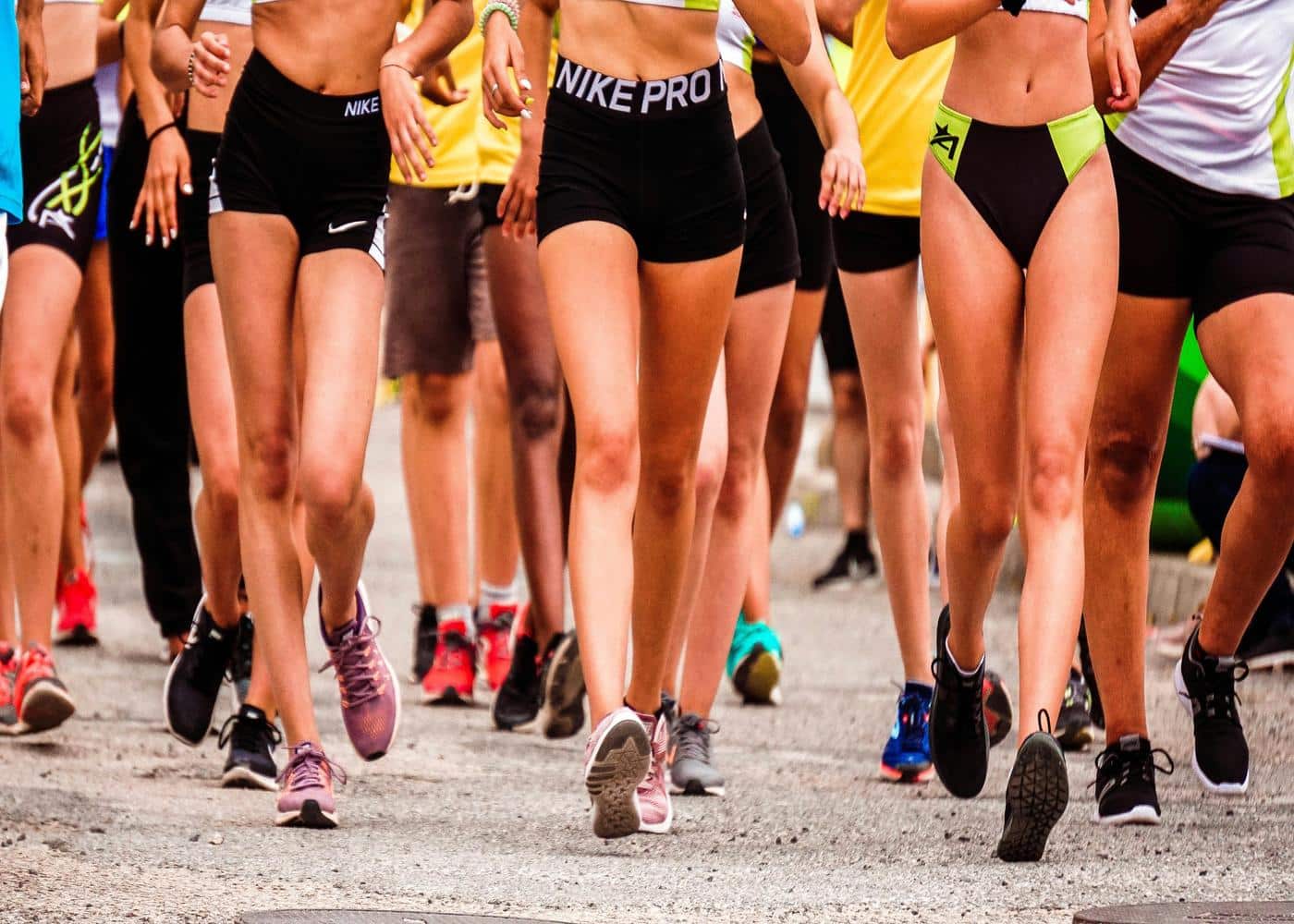 Waist down shot of women wearing running shoes starting a marathon