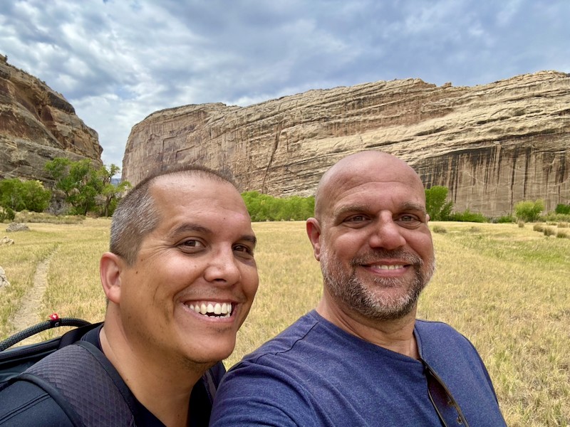Photo of John and Dustin on a hike smiling