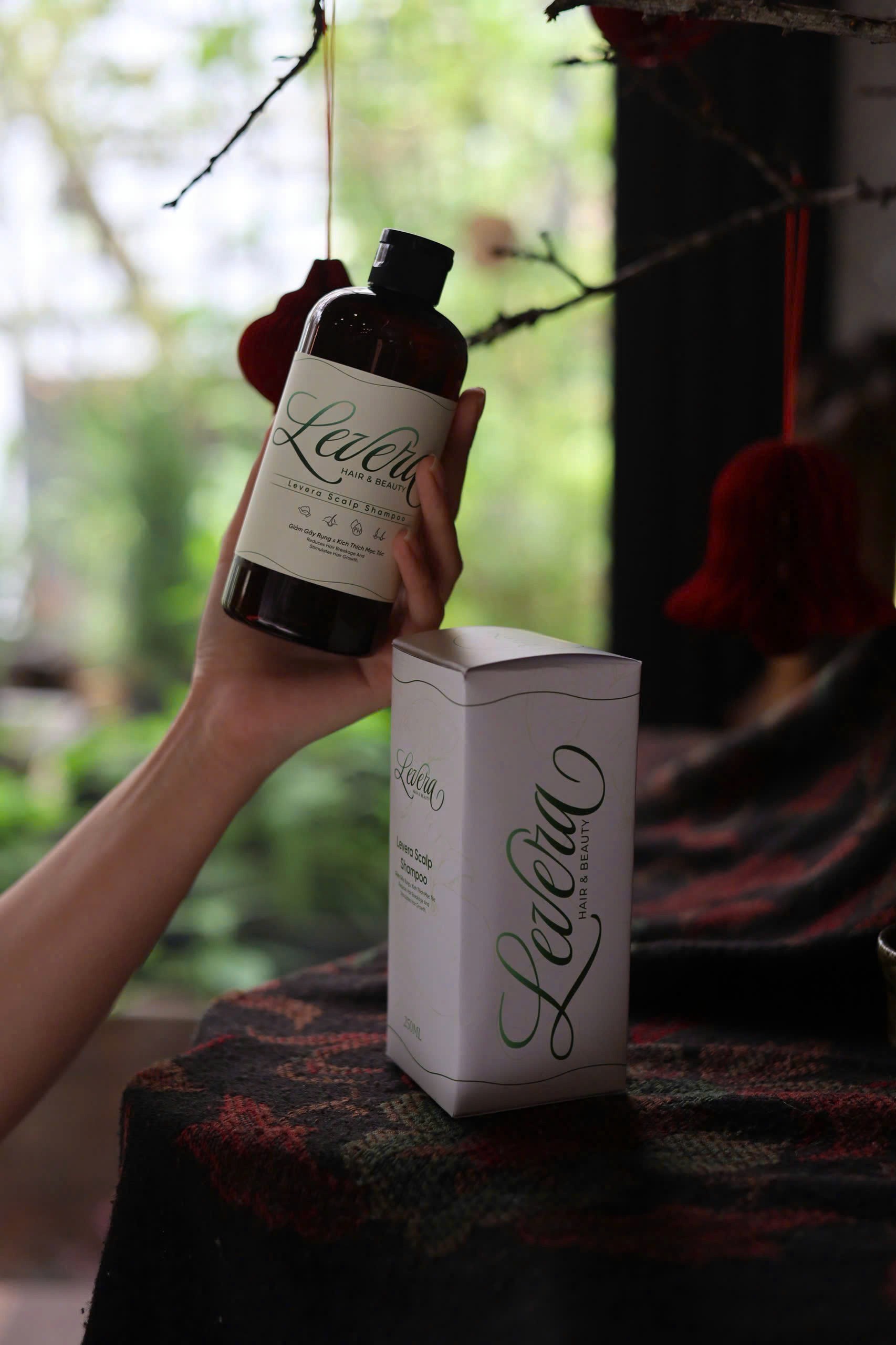 Moisturizing shampoo bottle on a neutral background.