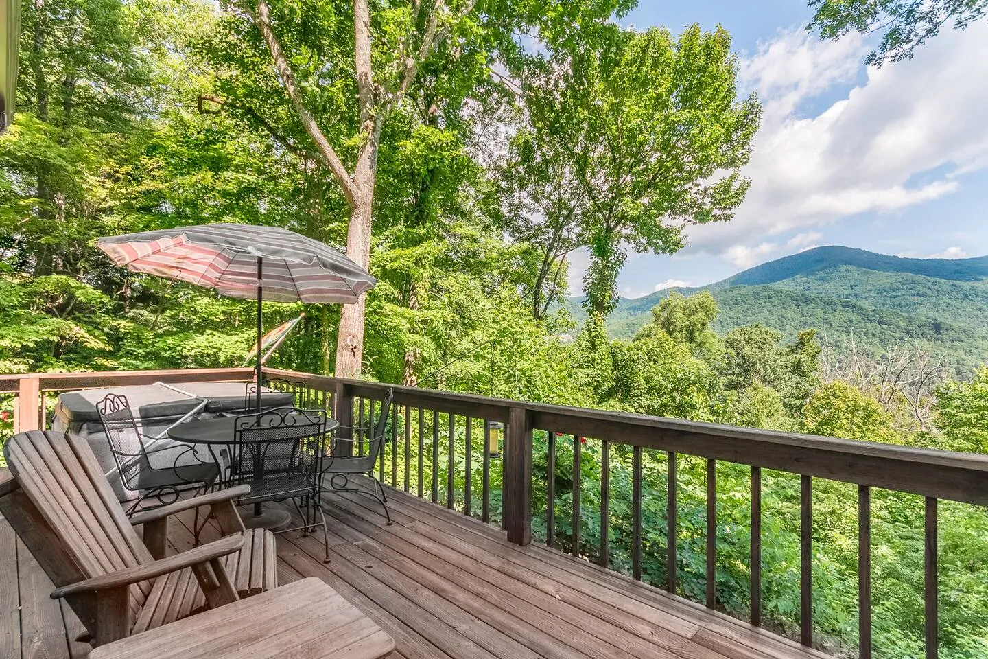 Bella Vista deck with umbrella table, rocking chairs and a summer view