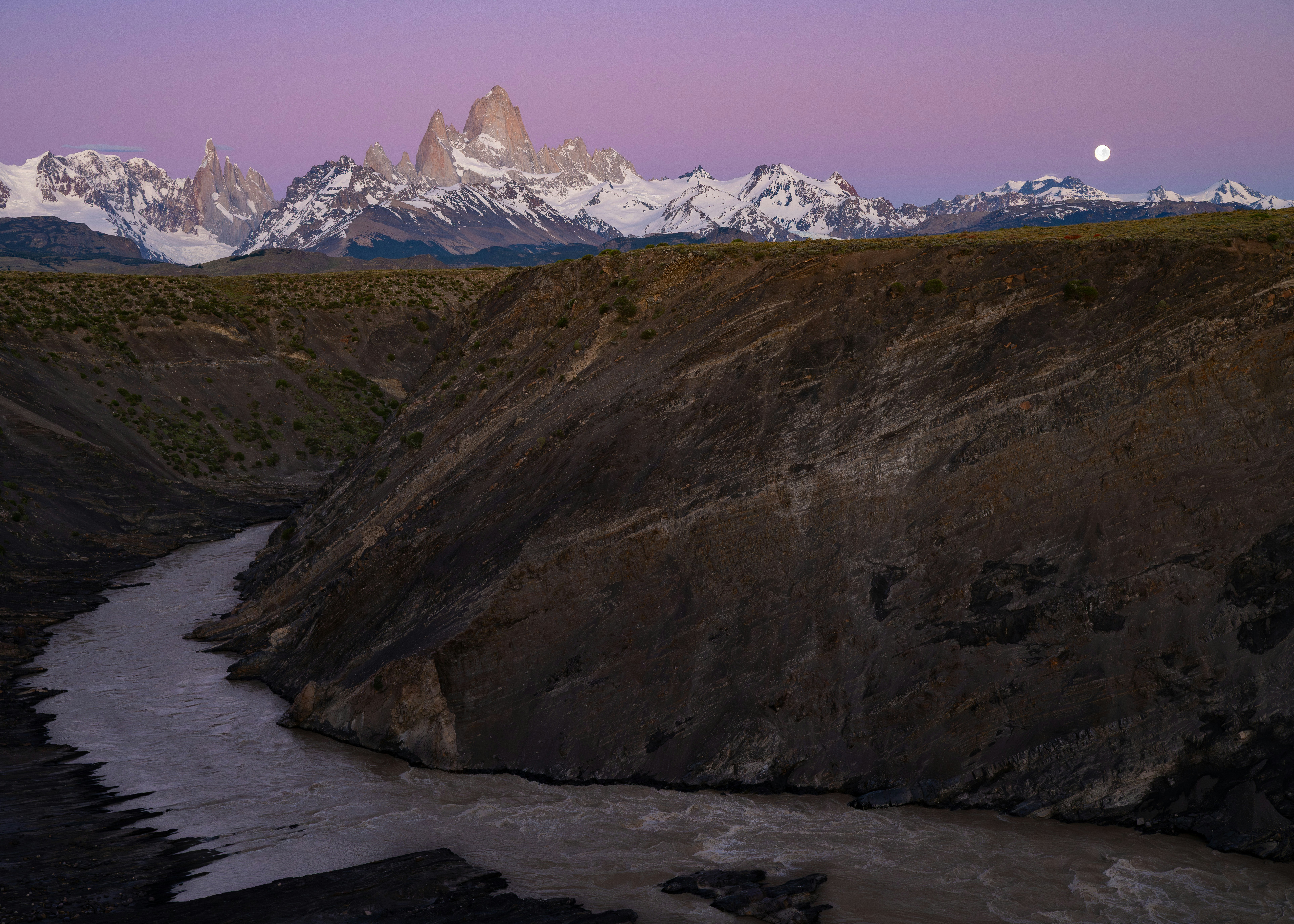 a snow covered field with trees in the background