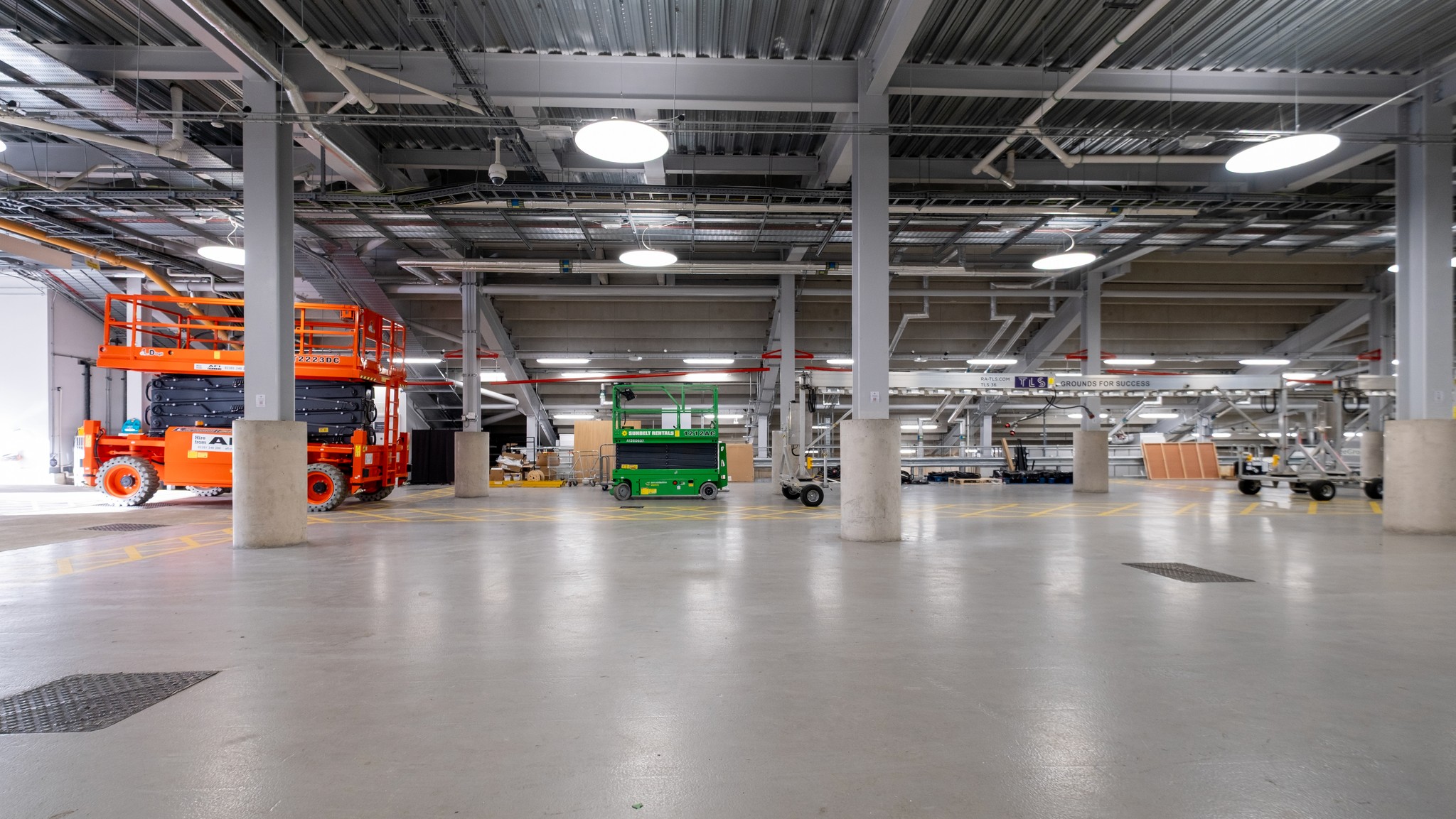 Two classic volkswagen beetles, one green, one cream.
