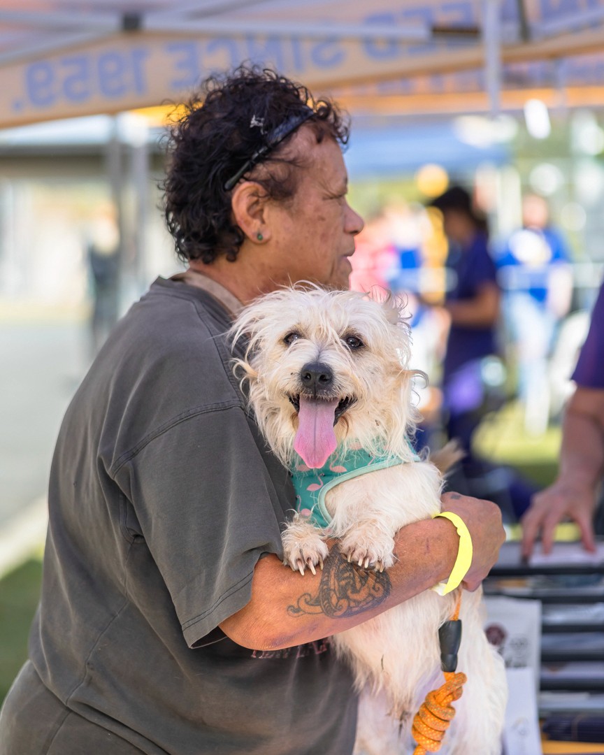 Women holding little white fluffy dog