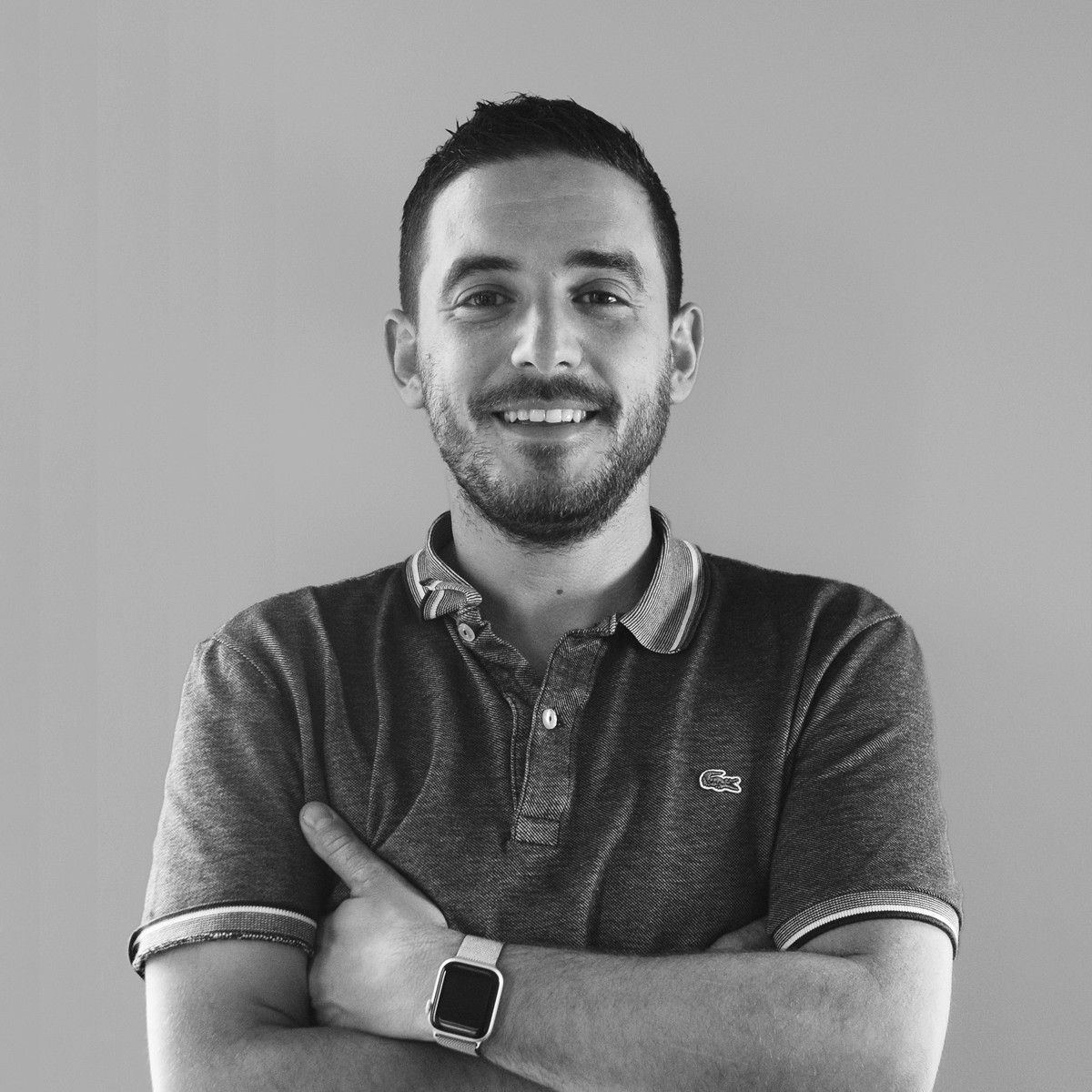 Portrait of a person in dark clothing speaking on a phone