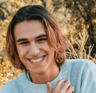 woman in gray sweater standing on brown grass field during daytime
