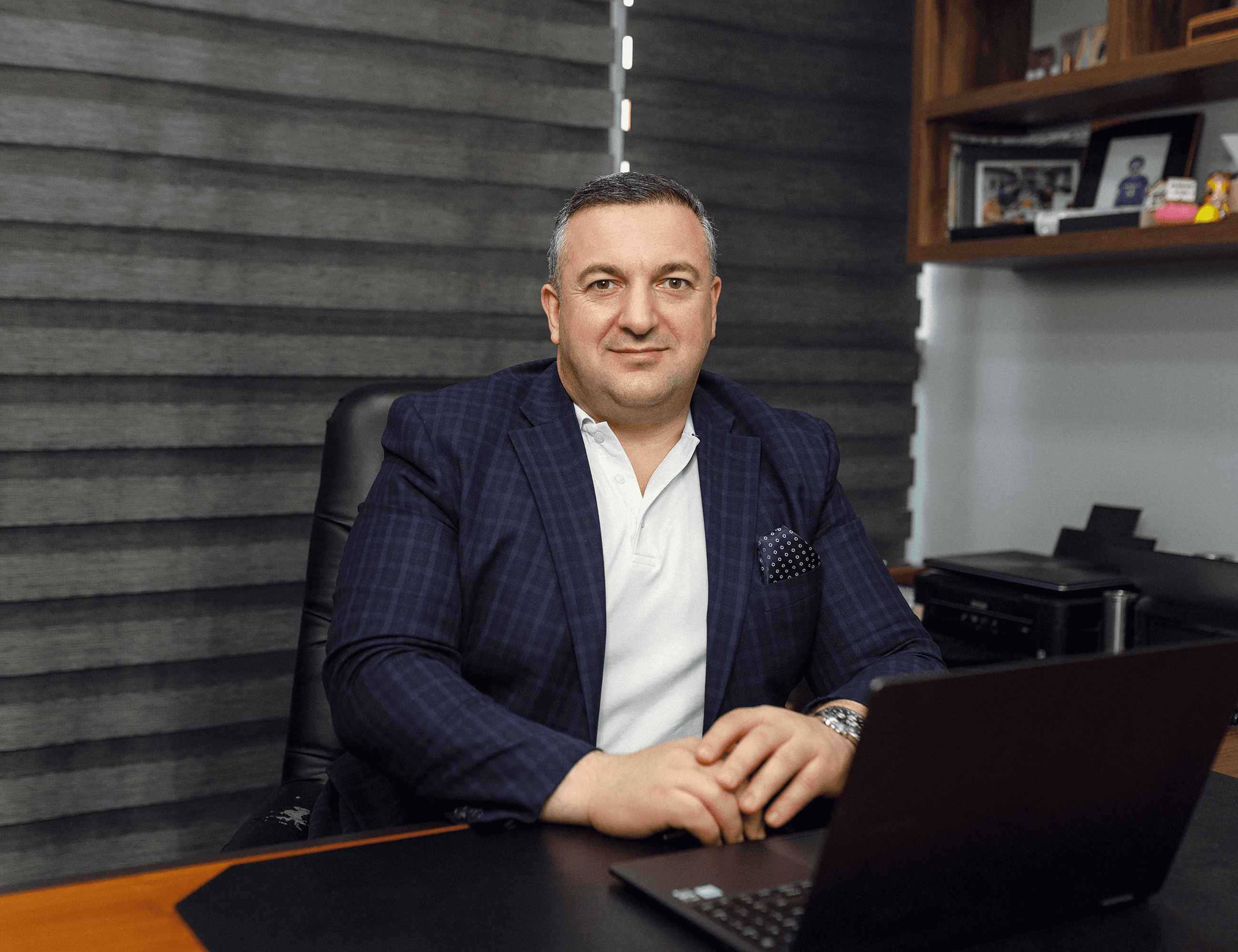 a man in the office who sits on a desk