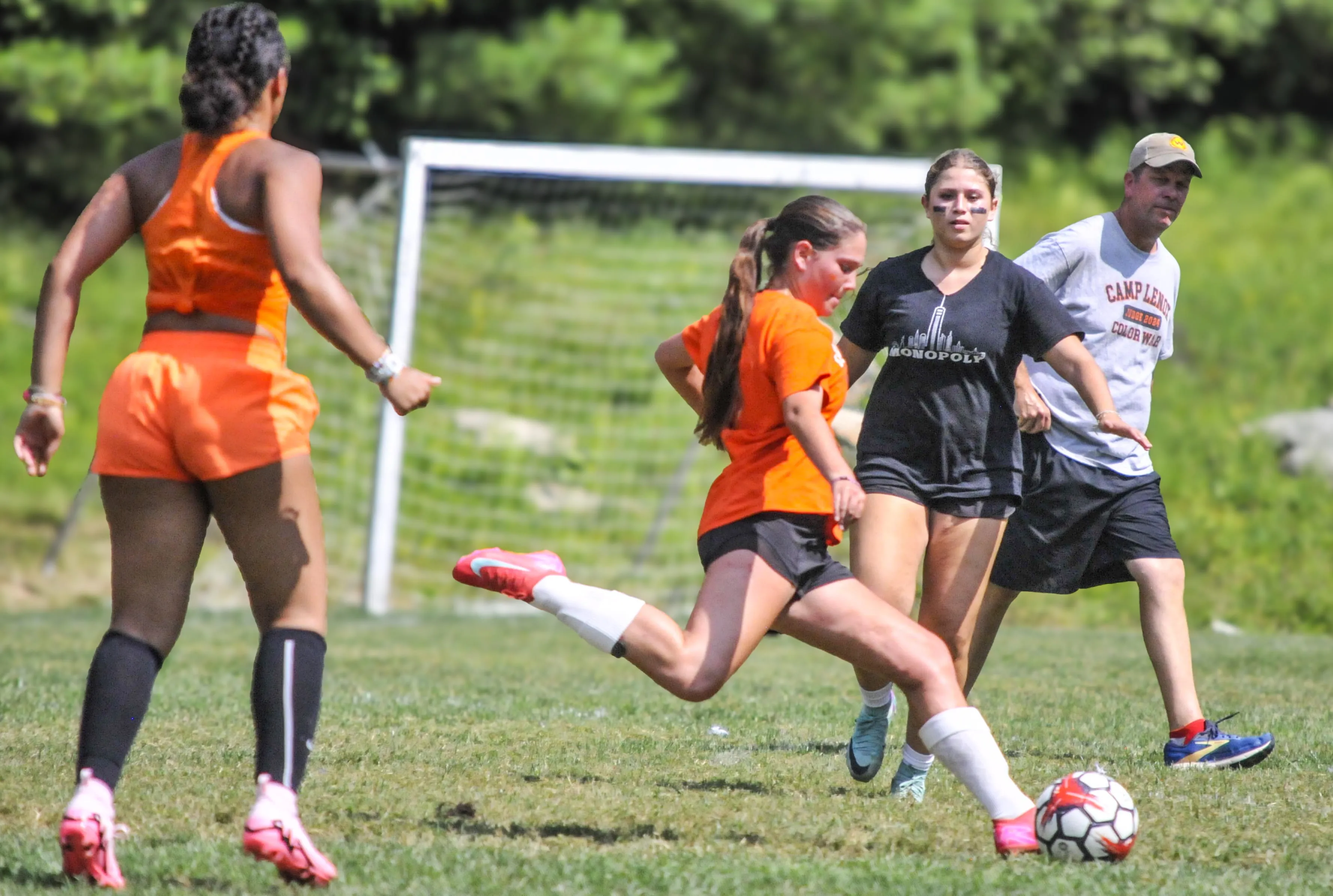 Campers competing for the ball during a soccer match