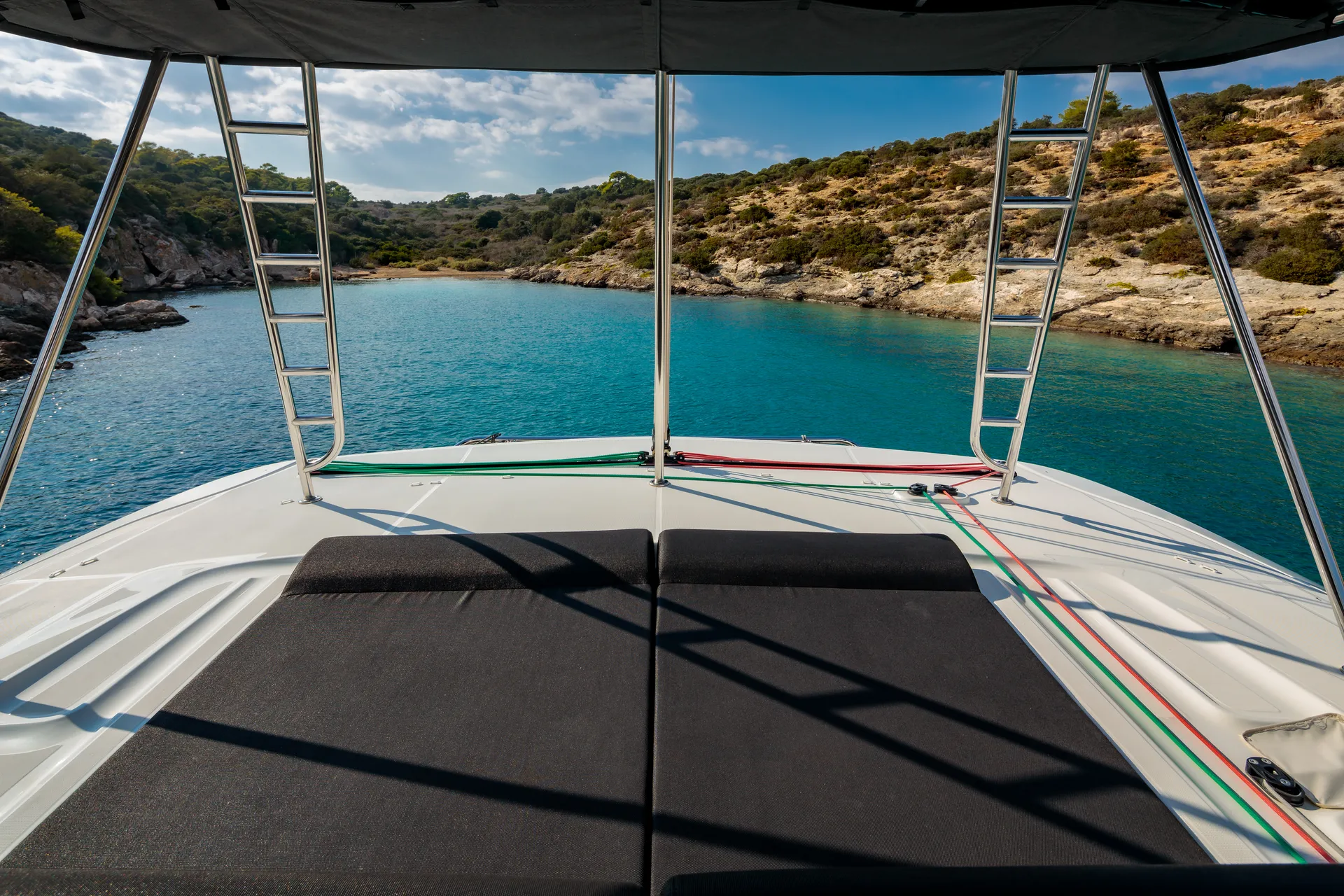 White Rock 36 speedboat with captain at helm cruising calm blue waters near Paros coastline with hills in background.