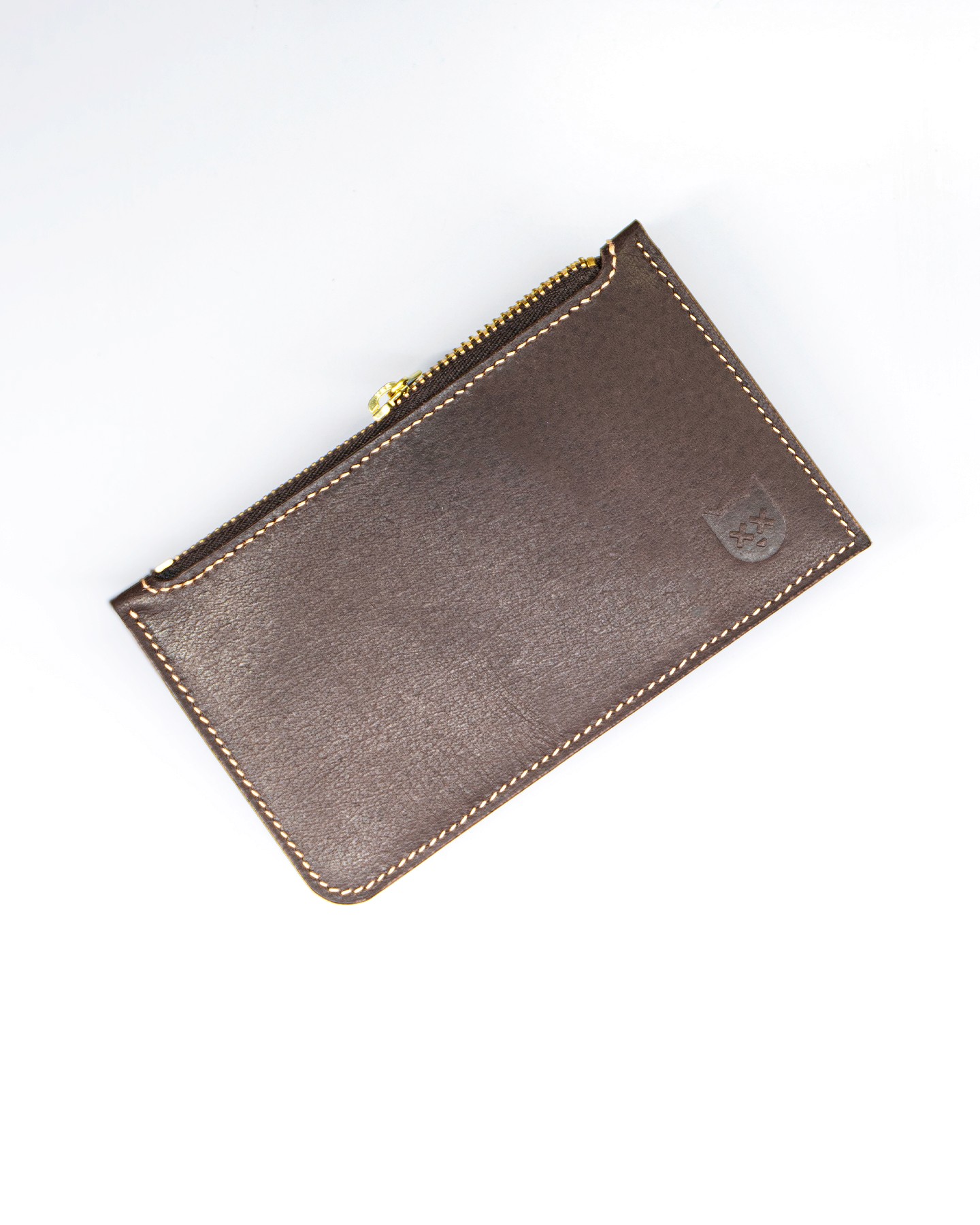 Interior of Crosstitch Leather’s brown vegetable-tanned money envelope, showing magnetic closure and internal pocket.