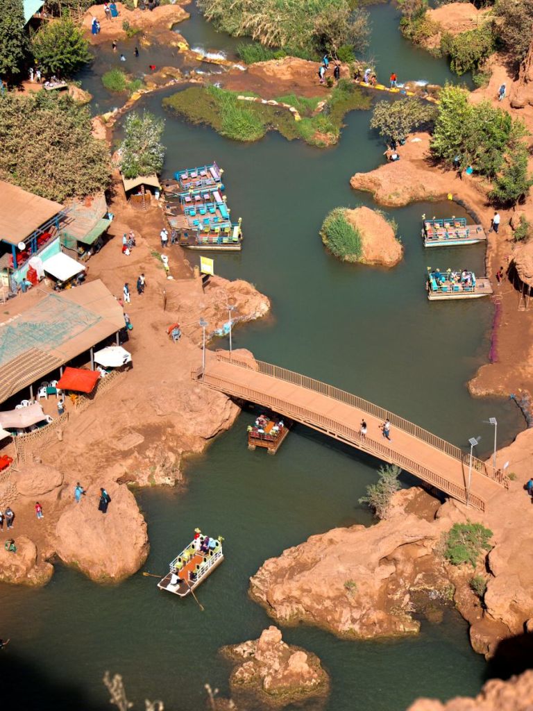 aerial view of boats and bridges at ouzoud waterfall