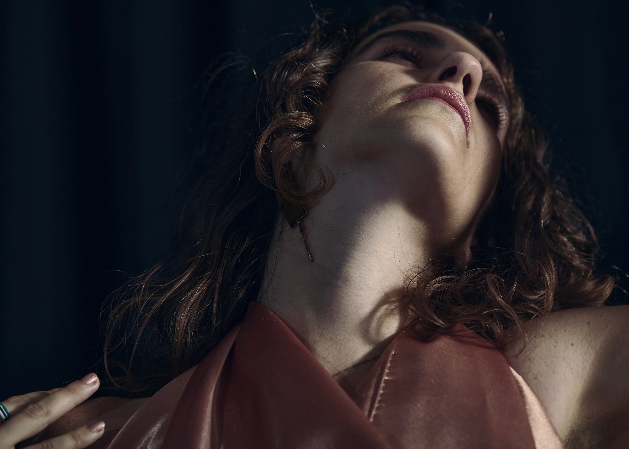 Dancer captured mid performance with artistic and expressive movements against a dark background.
