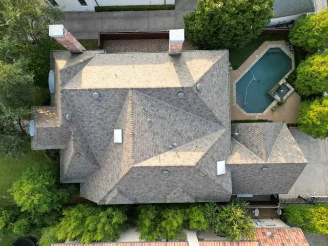 Drone view of completed F-Wave roof replacement on luxury home in Highland Park, TX by Arrington Roofing