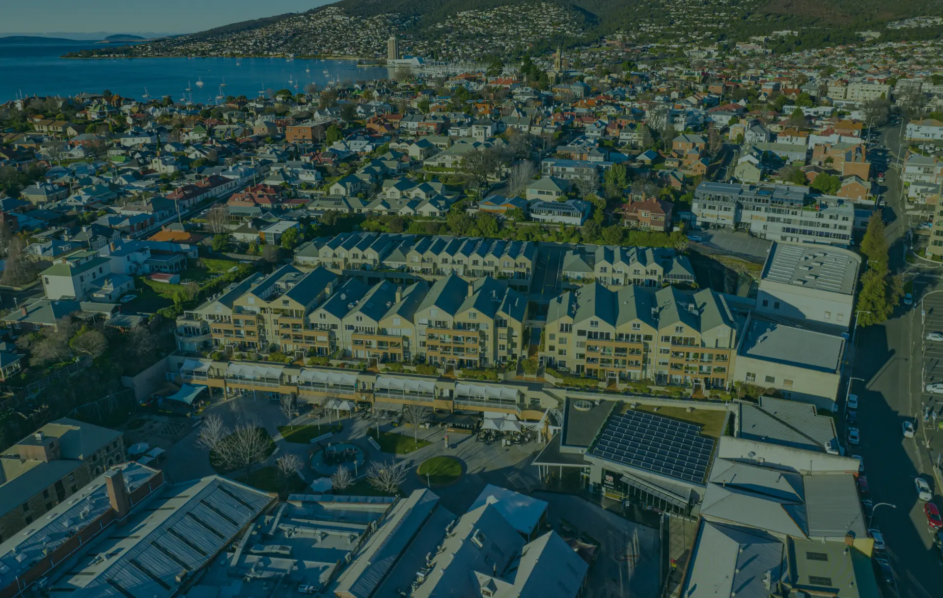 Row of modern apartment buildings overlooking a bay.