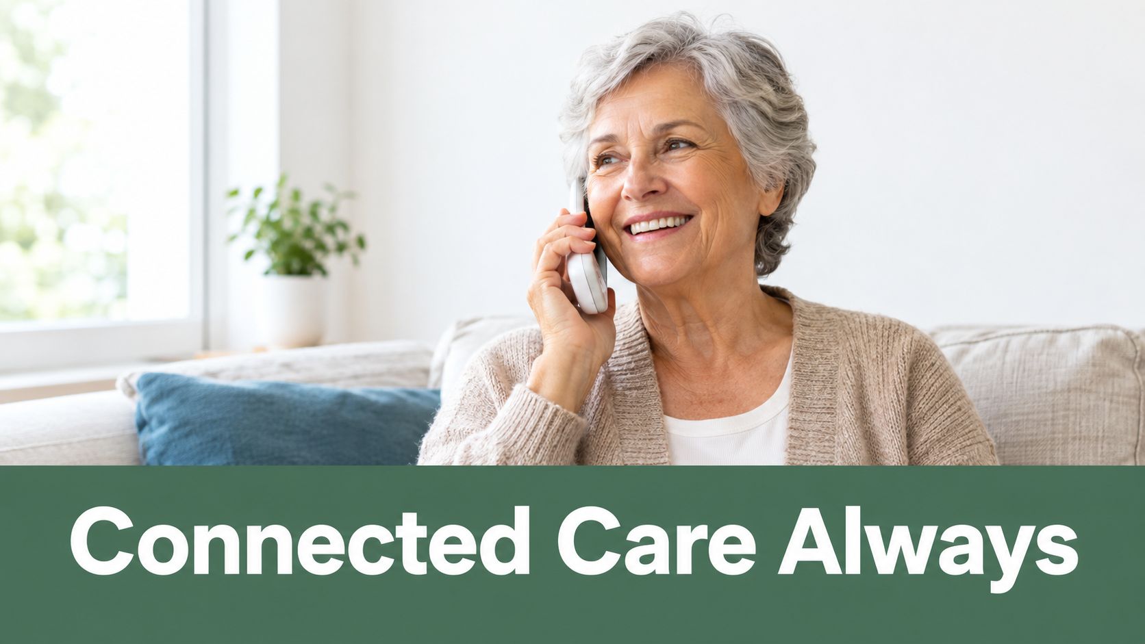 A cheerful elderly woman with grey hair smiling while talking on a phone at home.