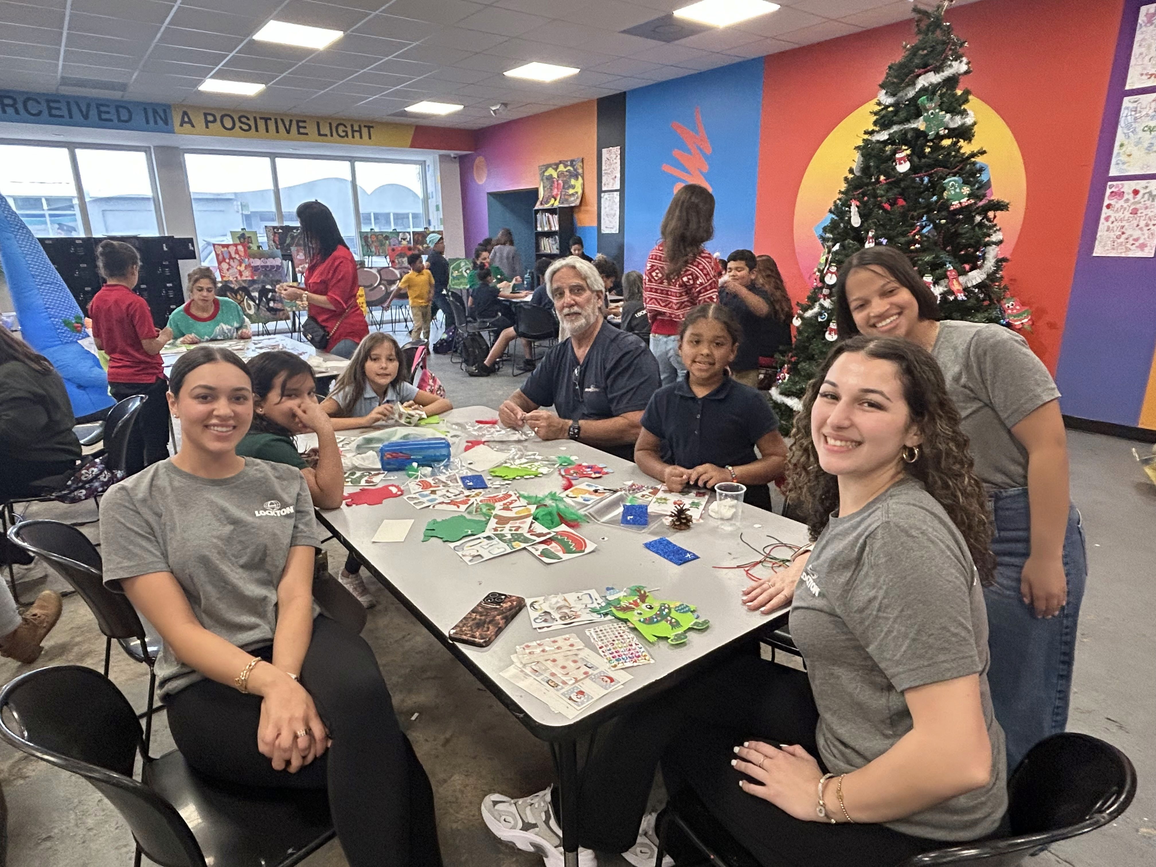 Lockton volunteers and Edge youth making holiday crafts together