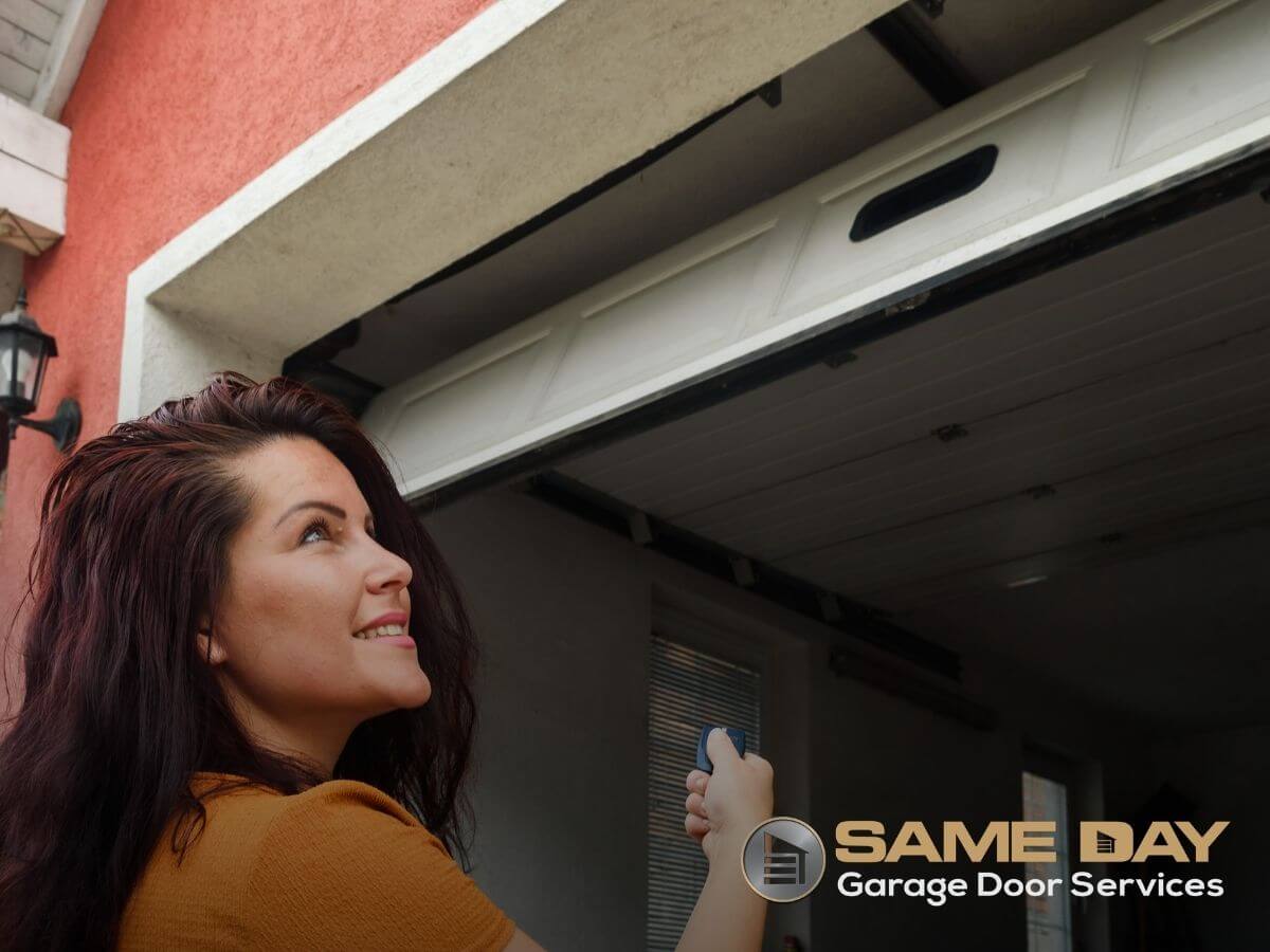 Woman opening her garage door, recently repaired by the experts at Same Day Garage Door