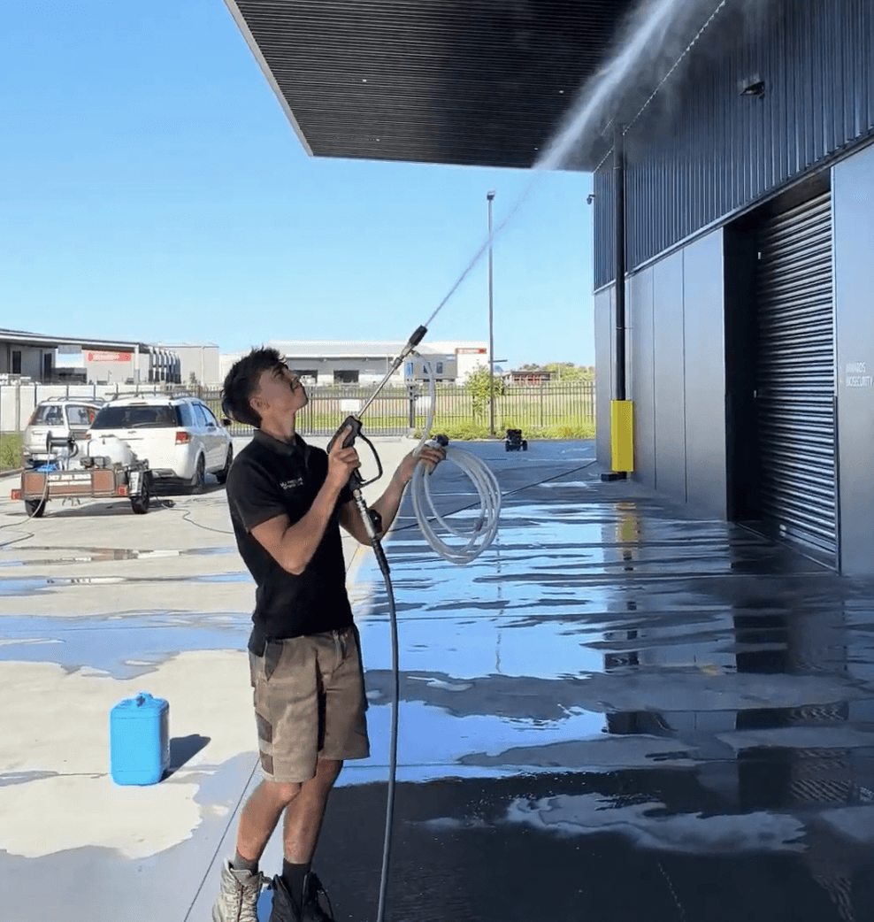 Max cleaning exterior windows on a Hamilton commercial building using a water fed pole