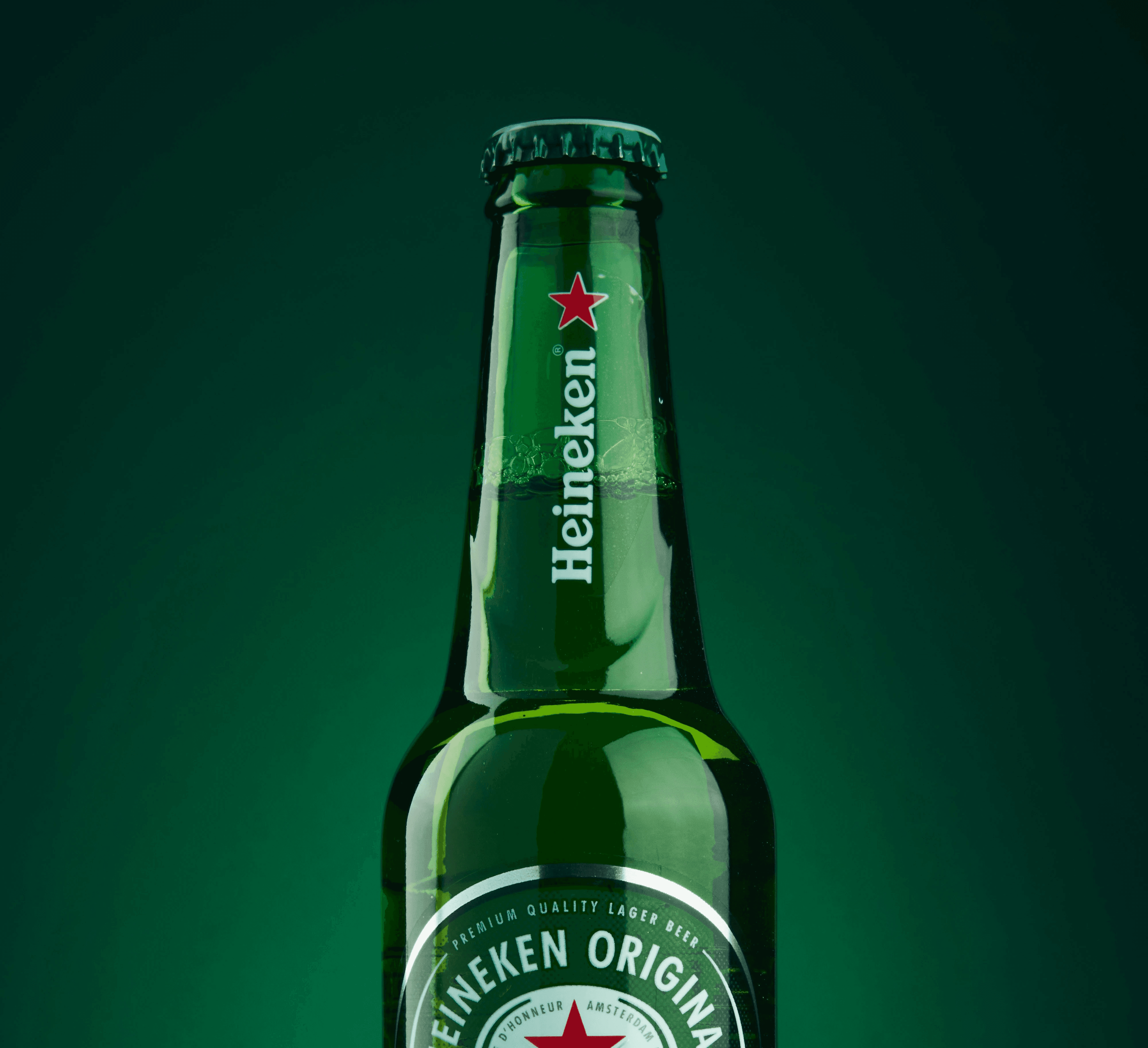 heineken beer bottle on green surface