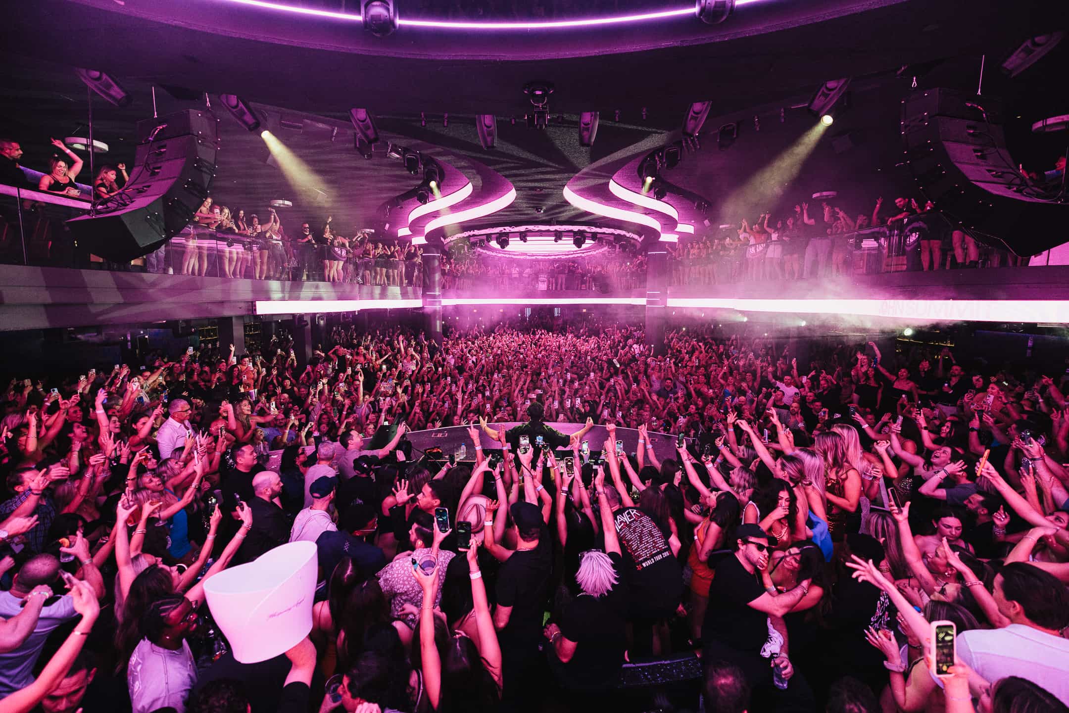 Wide angle view of LIV Las Vegas nightclub with packed crowd and multi level balcony during live DJ performance, photographed by A World Away