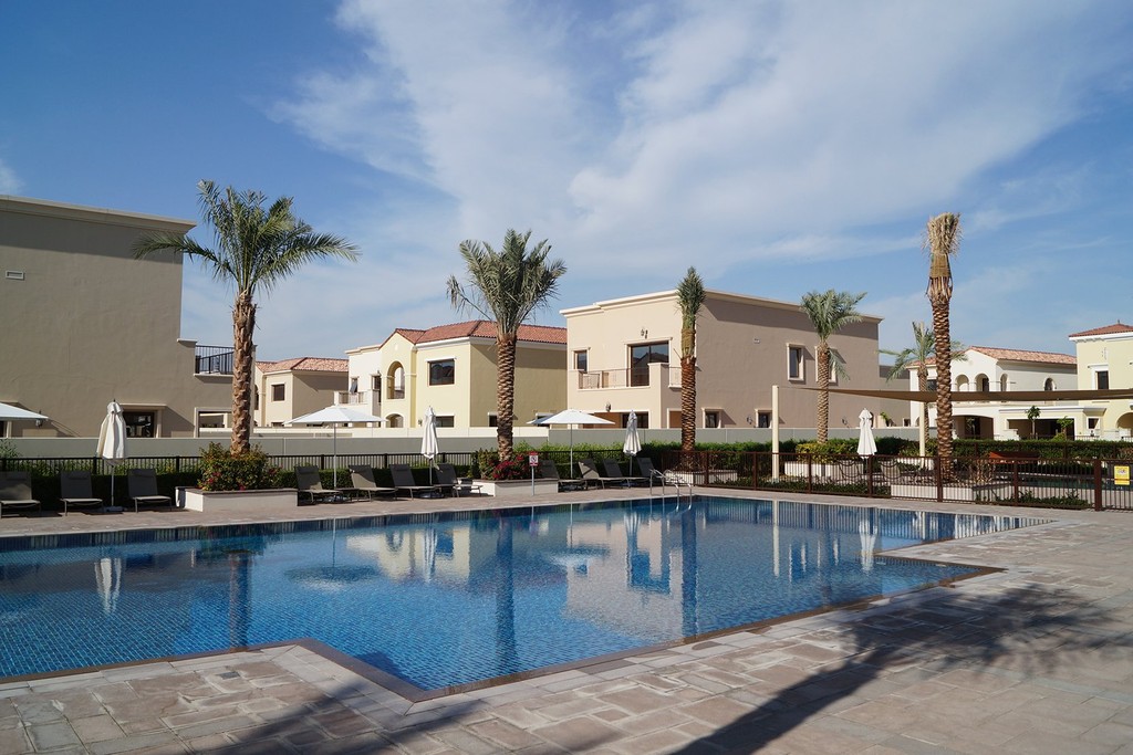 Overview of Arabian Ranches 2, highlighting spacious villas, palm trees, and well-maintained parks in a peaceful neighborhood.
