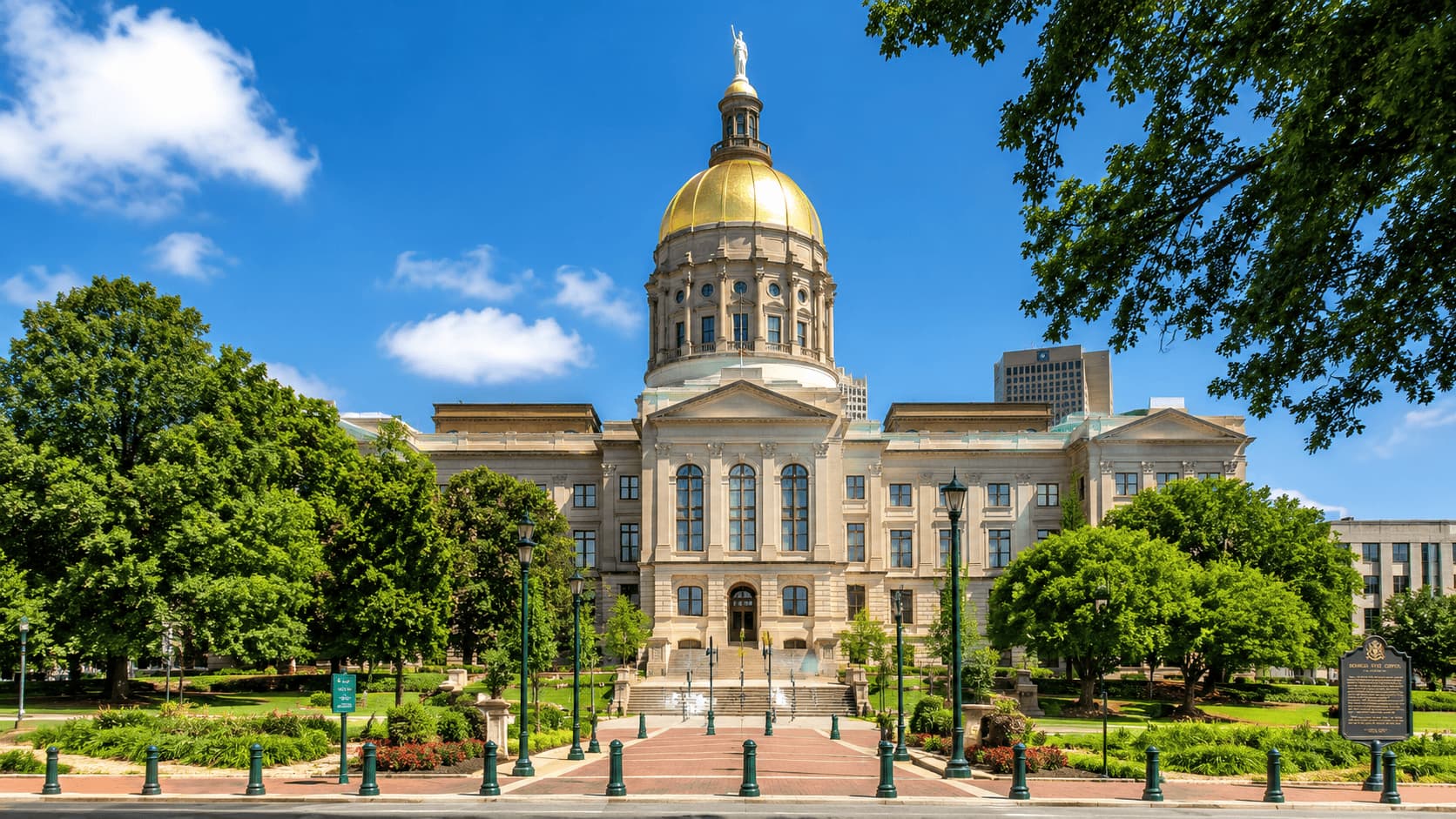 Georgia State Capitol in Atlanta with gold dome and surrounding greenery