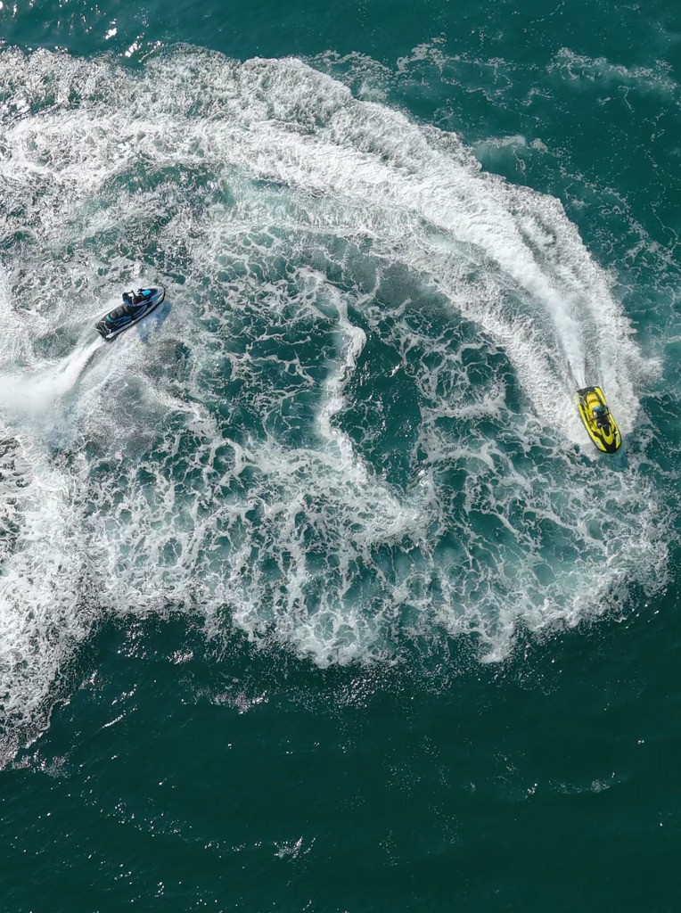 Jet skiing and water activities in Dubai captured from above, showcasing thrilling water sports offered by Ride in Dubai.