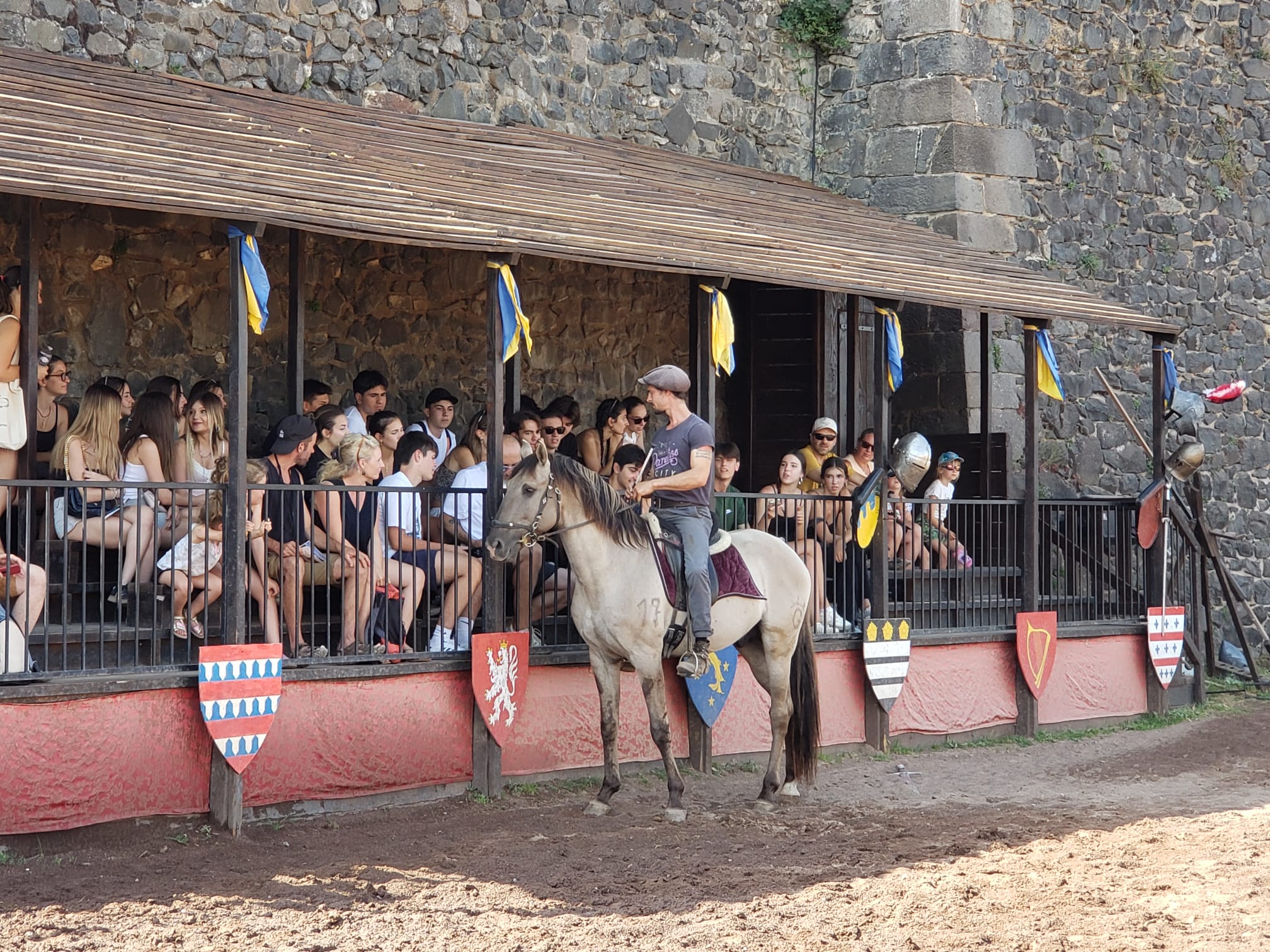 woman in white dress shirt and blue denim jeans sitting on green grass field during daytime
