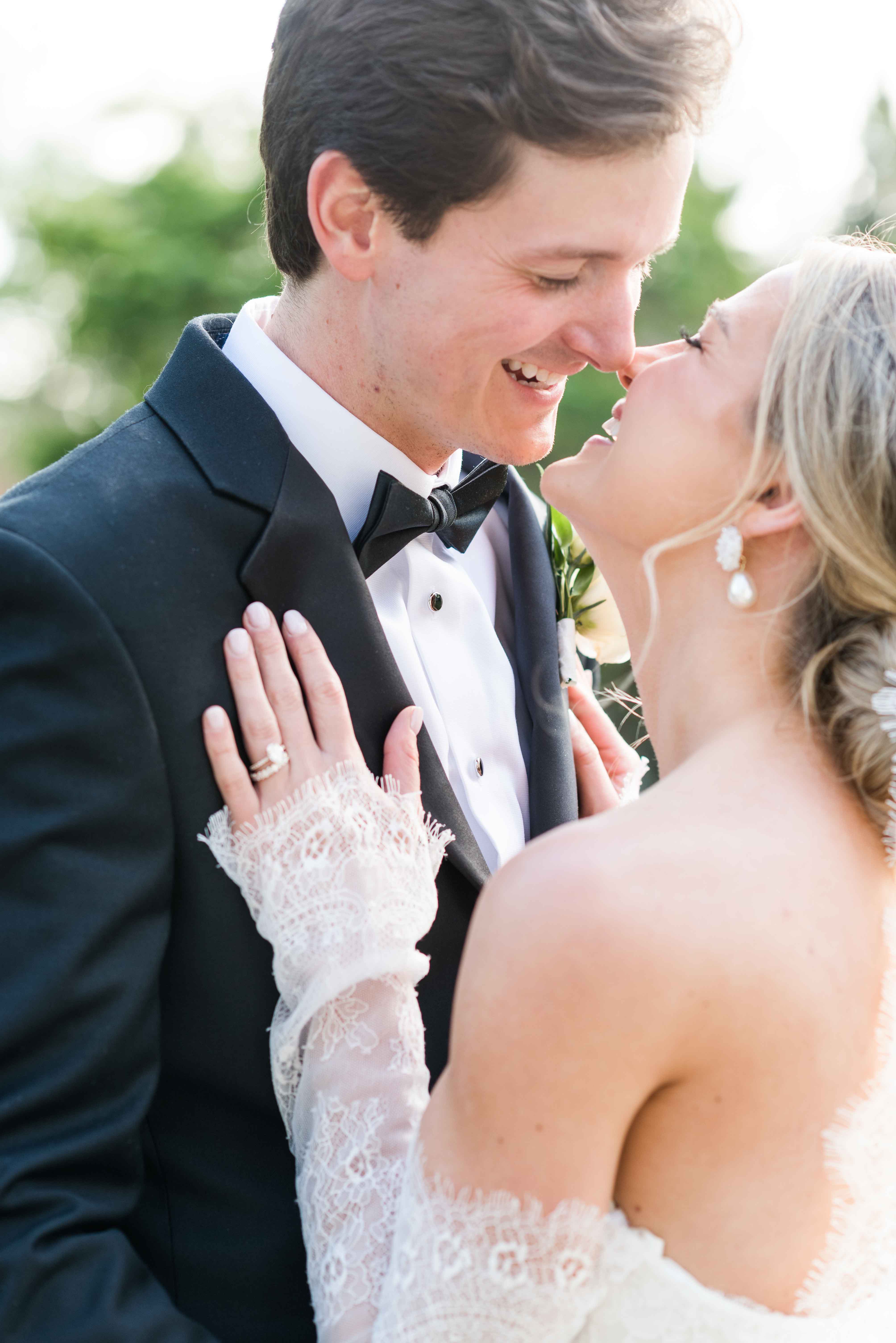 Close up image of bride and groom smiling at one another on their wedding day.